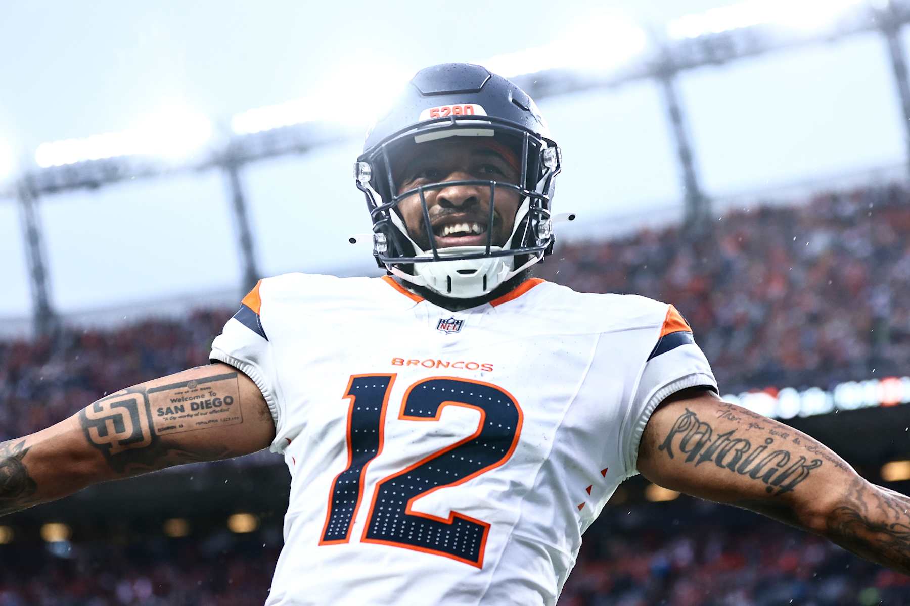 DENVER, COLORADO - AUGUST 18: Tim Patrick #12 of the Denver Broncos celebrates a touchdown in the second quarter during the preseason game against the Green Bay Packers at Empower Field At Mile High on August 18, 2024 in Denver, Colorado. (Photo by Tyler Schank/Getty Images)
