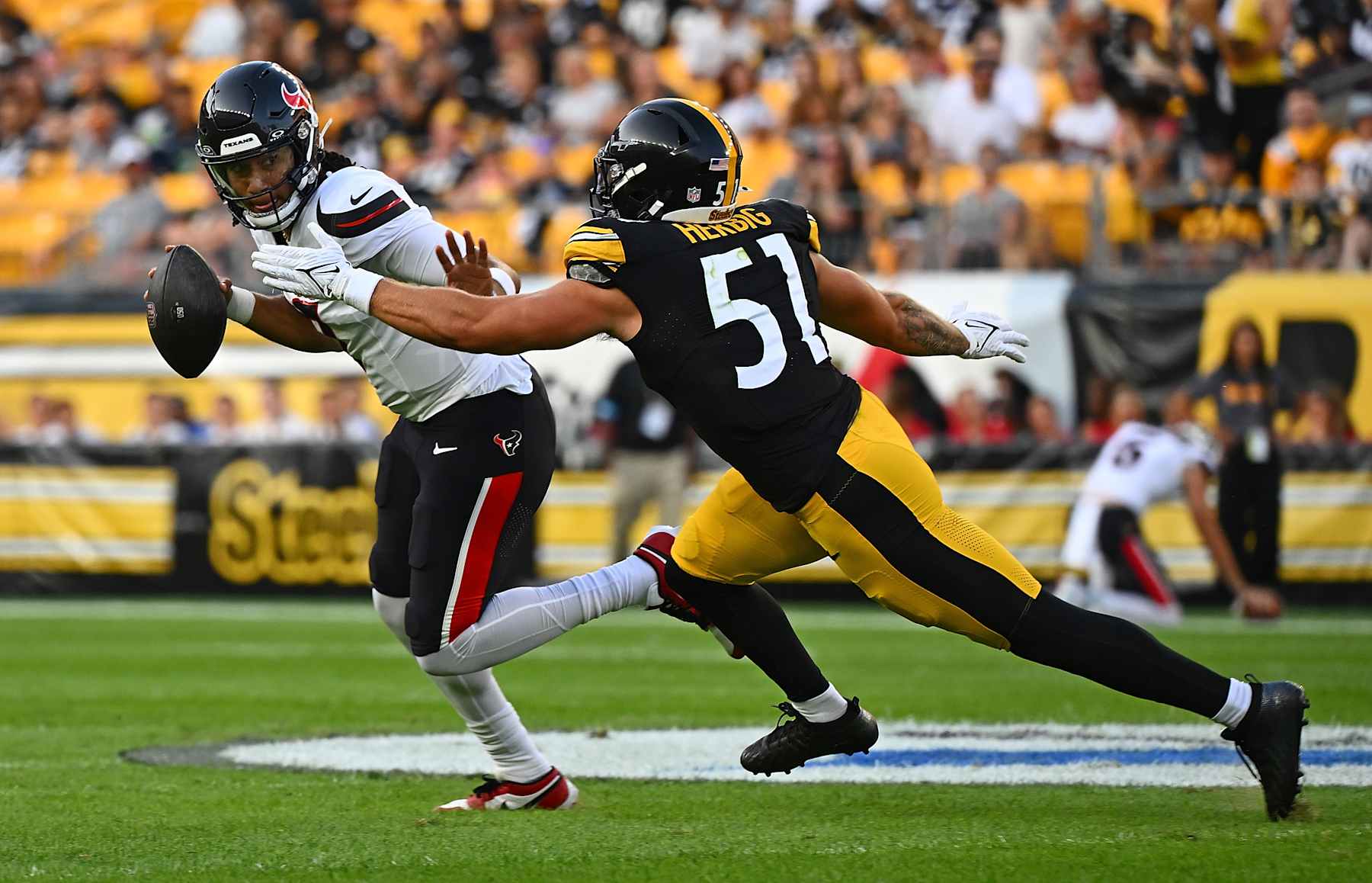 PITTSBURGH, PENNSYLVANIA - AUGUST 09: C.J. Stroud #7 of the Houston Texans scrambles under pressure from Nick Herbig #51 of the Pittsburgh Steelers in the first quarter during the preseason game at Acrisure Stadium on August 9, 2024 in Pittsburgh, Pennsylvania. (Photo by Justin Berl/Getty Images)