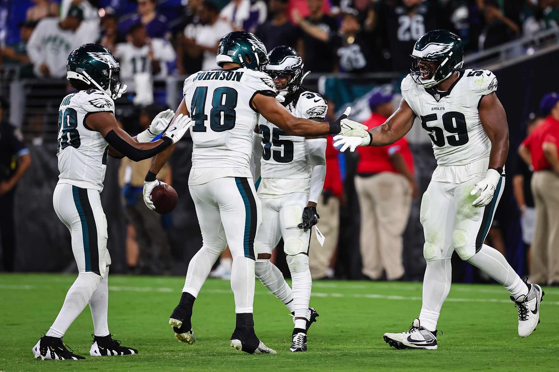 BALTIMORE, MD - AUGUST 09: Patrick Johnson #48 of the Philadelphia Eagles celebrates with Josh Jobe #28, Andre' Sam #35 and Thomas Booker IV #59 after recovering a fumble against the Baltimore Ravens during the second half of a preseason game at M&T Bank Stadium on August 9, 2024 in Baltimore, Maryland. (Photo by Scott Taetsch/Getty Images)
