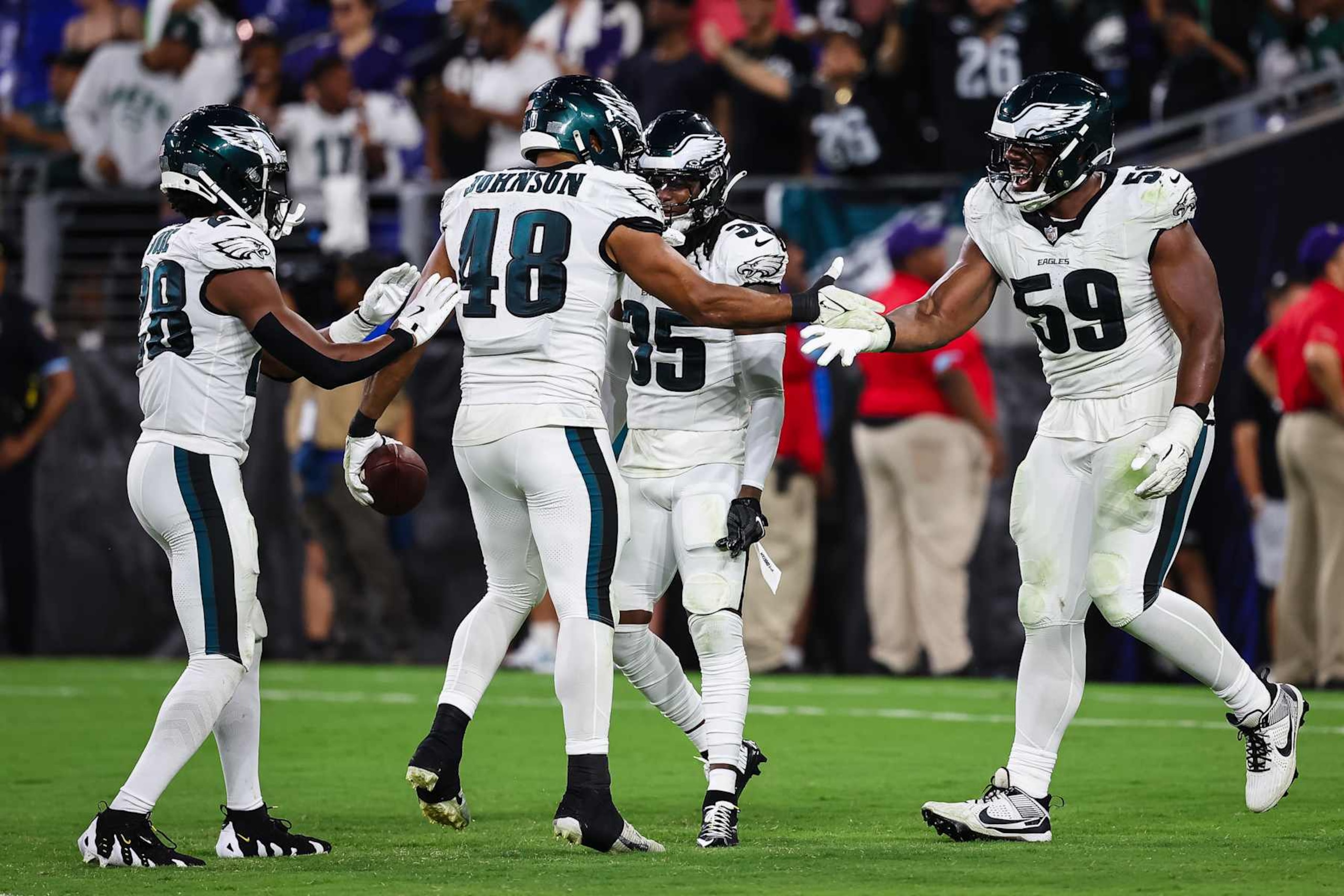 BALTIMORE, MD - AUGUST 09: Patrick Johnson #48 of the Philadelphia Eagles celebrates with Josh Jobe #28, Andre' Sam #35 and Thomas Booker IV #59 after recovering a fumble against the Baltimore Ravens during the second half of a preseason game at M&T Bank Stadium on August 9, 2024 in Baltimore, Maryland. (Photo by Scott Taetsch/Getty Images)
