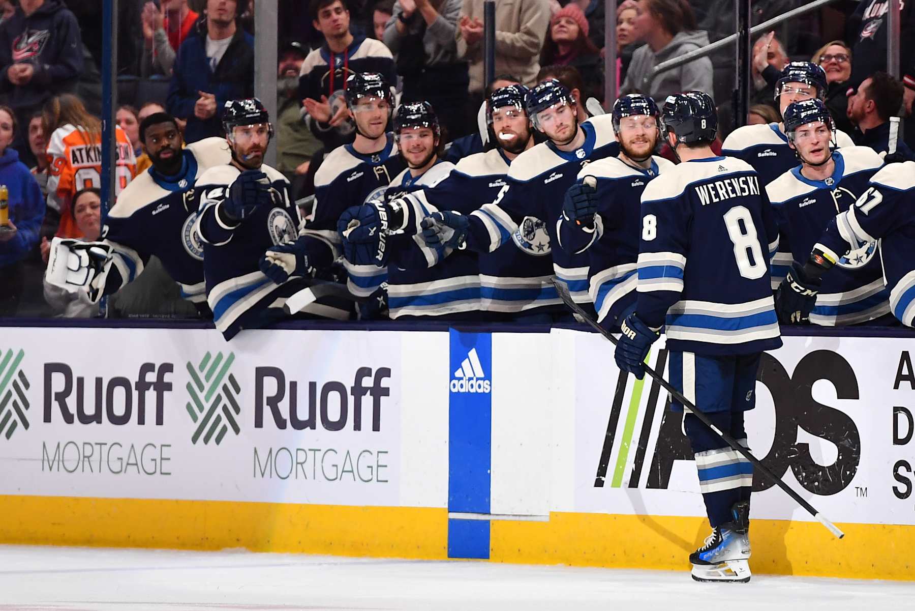 COLUMBUS, OHIO - APRIL 6: Zach Werenski #8 of the Columbus Blue Jackets high-fives his teammates after scoring a goal during the third period of a game against the Philadelphia Flyers at Nationwide Arena on April 6, 2024 in Columbus, Ohio. (Photo by Ben Jackson/NHLI via Getty Images)
