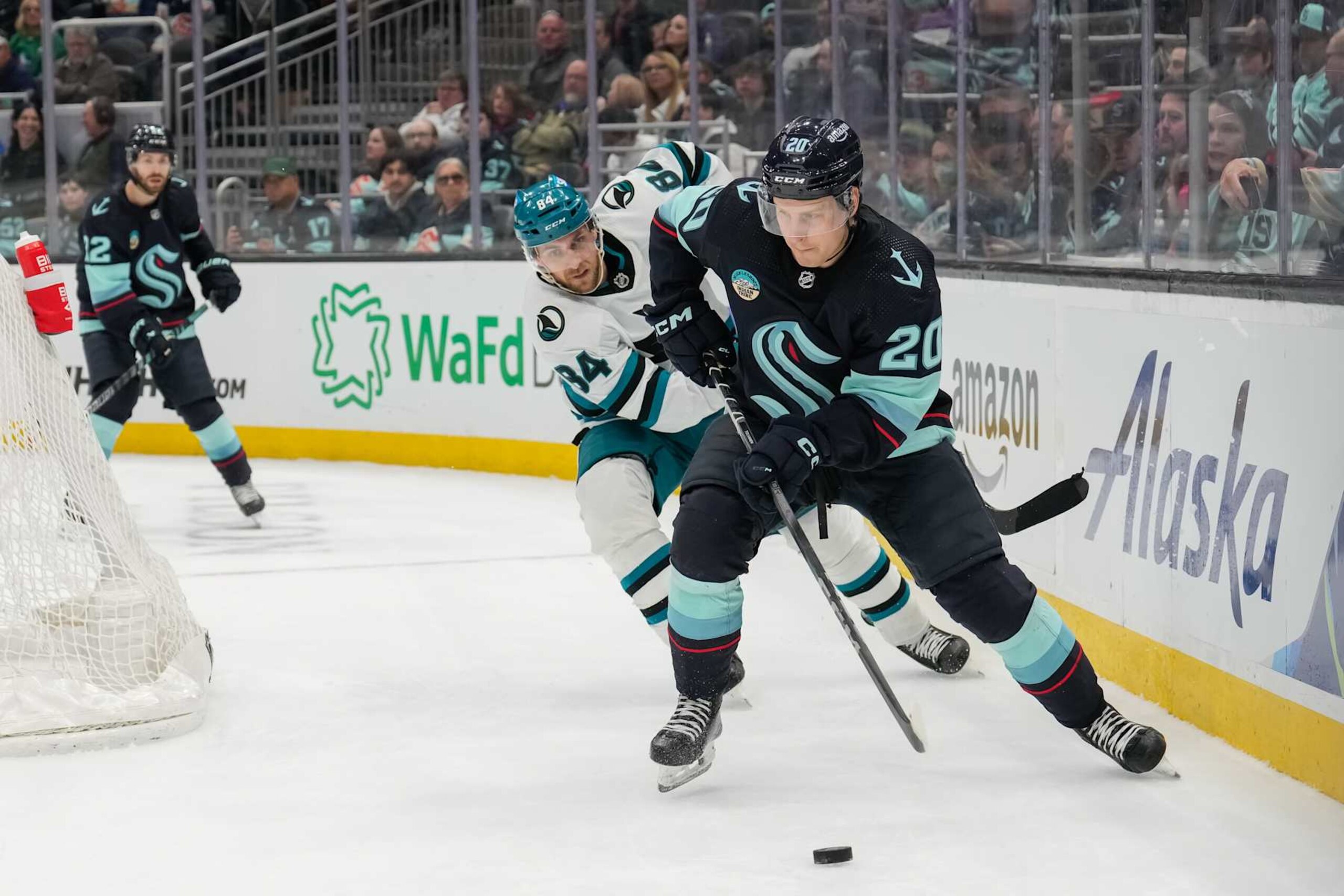 SEATTLE, WASHINGTON - APRIL 11: Eeli Tolvanen #20 of the Seattle Kraken skates the puck away from Jan Rutta #84 of the San Jose Sharks during the third period of a game at Climate Pledge Arena on April 11, 2024 in Seattle, Washington. (Photo by Christopher Mast/NHLI via Getty Images) SEATTLE, WASHINGTON - APRIL 11: Eeli Tolvanen #20 of the Seattle Kraken skates the puck away from Jan Rutta #84 of the San Jose Sharks during the third period of a game at Climate Pledge Arena on April 11, 2024 in Seattle, Washington. (Photo by Christopher Mast/NHLI via Getty Images)
