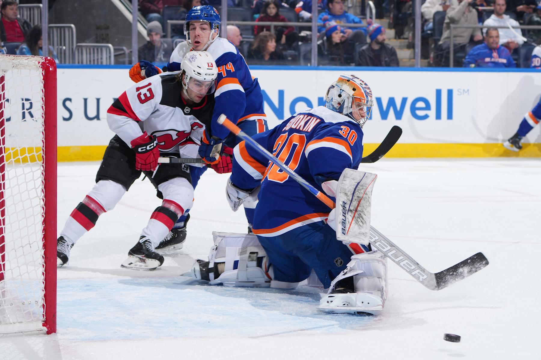 ELMONT, NEW YORK - MARCH 24: Ilya Sorokin #30 and Jean-Gabriel Pageau #44 of the New York Islanders defend shot on goal by Nico Hischier #13 of the New Jersey Devils at UBS Arena on March 24, 2024 in Elmont, New York. (Photo by Mike Stobe/NHLI via Getty Images)