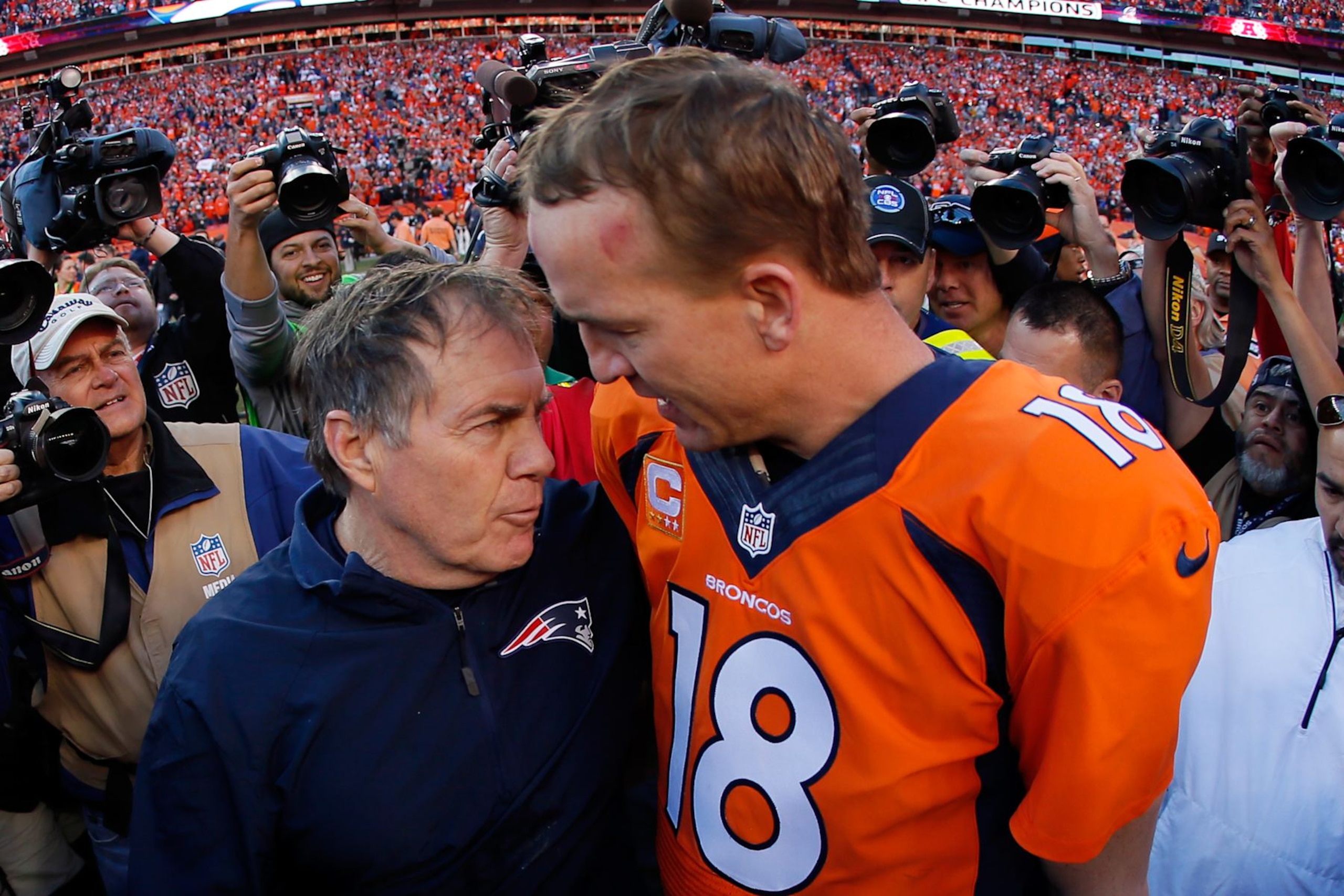 DENVER, CO - JANUARY 19: Head coach Bill Belichick of the New England Patriots congratulates Peyton Manning #18 of the Denver Broncos after the Broncos defeated the New England Patriots 26 to 16 during the AFC Championship game at Sports Authority Field at Mile High on January 19, 2014 in Denver, Colorado. (Photo by Kevin C. Cox/Getty Images) DENVER, CO - JANUARY 19: Head coach Bill Belichick of the New England Patriots congratulates Peyton Manning #18 of the Denver Broncos after the Broncos defeated the New England Patriots 26 to 16 during the AFC Championship game at Sports Authority Field at Mile High on January 19, 2014 in Denver, Colorado. (Photo by Kevin C. Cox/Getty Images)
