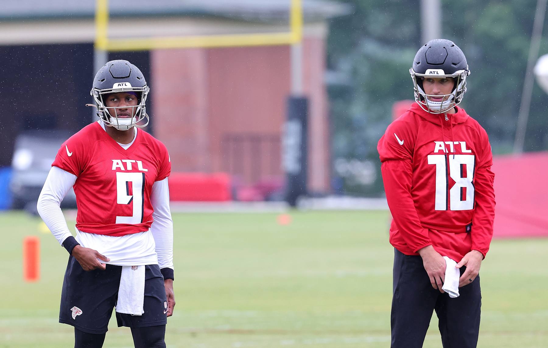 FLOWERY BRANCH, GEORGIA - MAY 14:  Quarterbacks Kirk Cousins #18 and Michael Penix Jr. #9 of the Atlanta Falcons look on during OTA offseason workouts at the Atlanta Falcons training facility on May 14, 2024 in Flowery Branch, Georgia. (Photo by Kevin C. Cox/Getty Images)