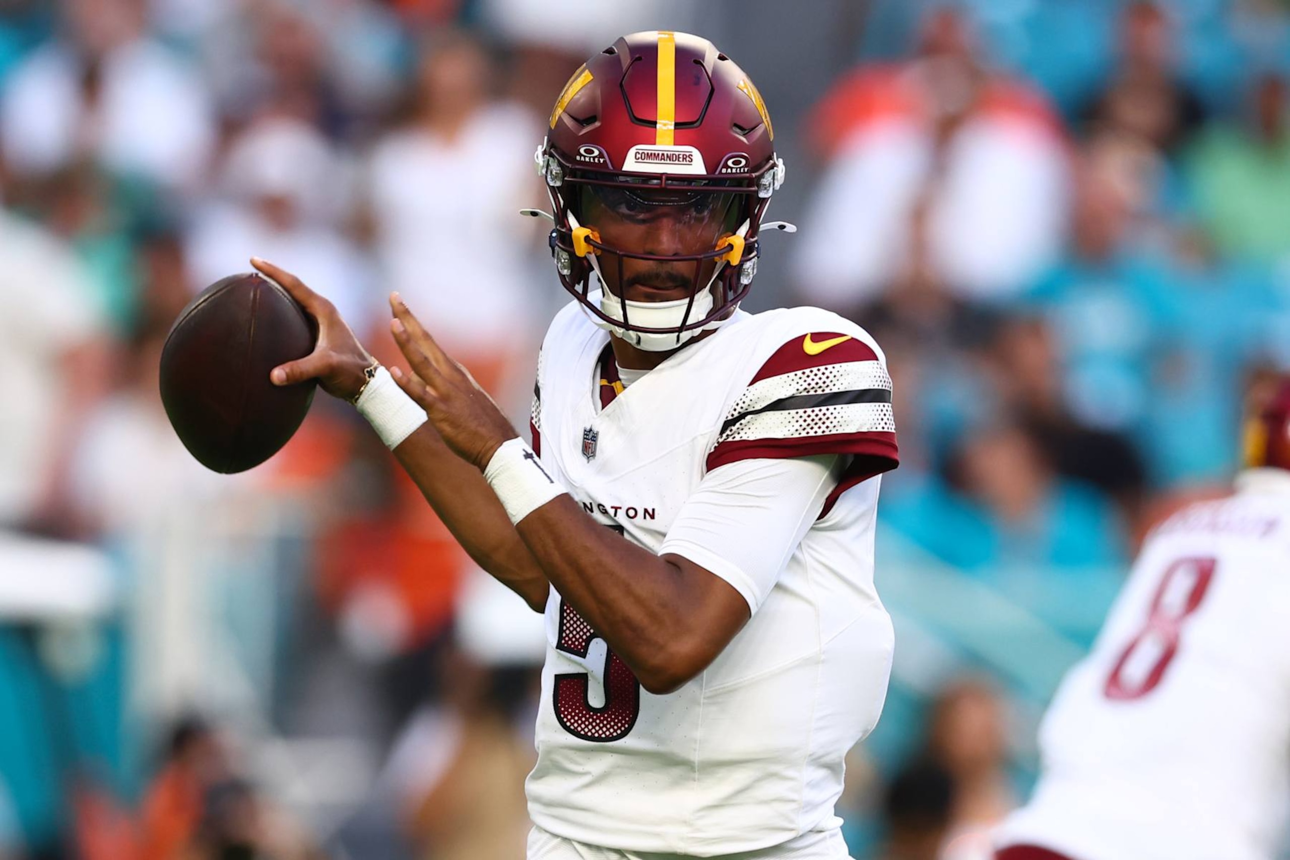 MIAMI GARDENS, FLORIDA - AUGUST 17: Jayden Daniels #5 of the Washington Commanders throws a pass against the Miami Dolphins during the first quarter of a preseason game at Hard Rock Stadium on August 17, 2024 in Miami Gardens, Florida. (Photo by Megan Briggs/Getty Images)