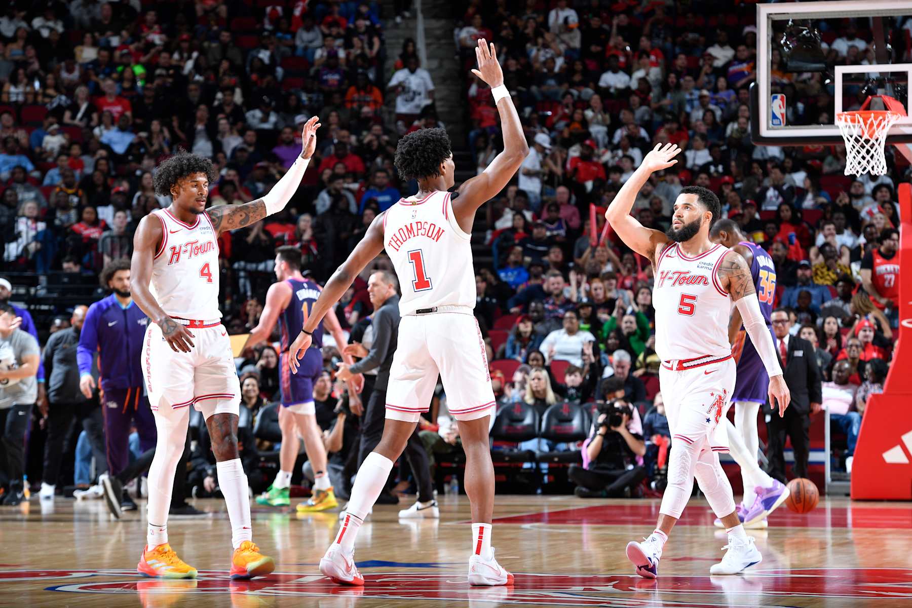 HOUSTON, TX - FEBRUARY 23: Jalen Green #4, Amen Thompson #1 and Fred VanVleet #5 of the Houston Rockets  high five during the game against the Phoenix Suns on February 23, 2024 at the Toyota Center in Houston, Texas. NOTE TO USER: User expressly acknowledges and agrees that, by downloading and or using this photograph, User is consenting to the terms and conditions of the Getty Images License Agreement. Mandatory Copyright Notice: Copyright 2024 NBAE (Photo by Logan Riely/NBAE via Getty Images)