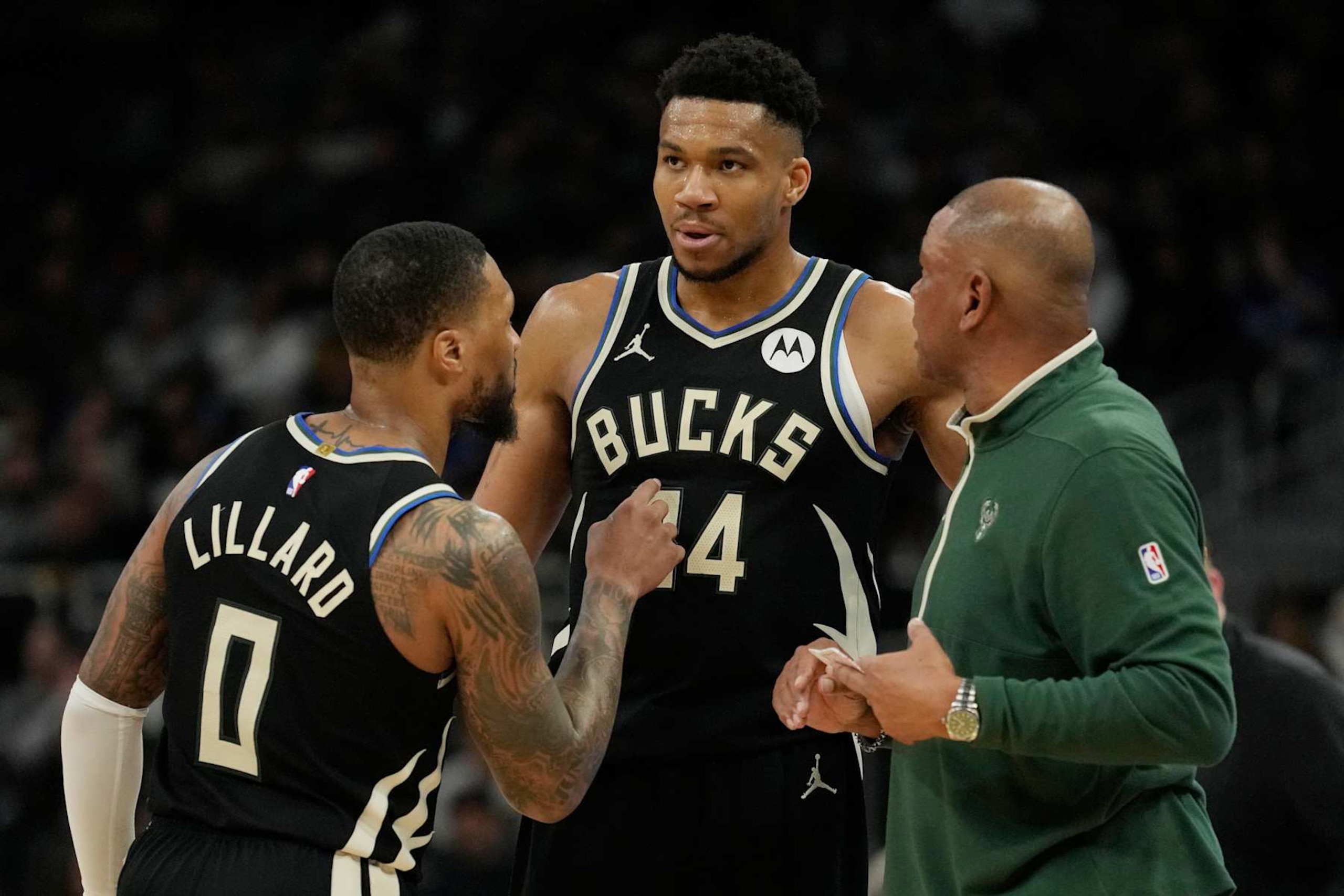 MILWAUKEE, WISCONSIN - APRIL 07: Damian Lillard #0, Giannis Antetokounmpo #34 and ead coach Doc Rivers of the Milwaukee Bucks talk during the first half of the game against the New York Knicks at Fiserv Forum on April 07, 2024 in Milwaukee, Wisconsin. NOTE TO USER: User expressly acknowledges and agrees that, by downloading and or using this photograph, User is consenting to the terms and conditions of the Getty Images License Agreement. (Photo by Patrick McDermott/Getty Images)