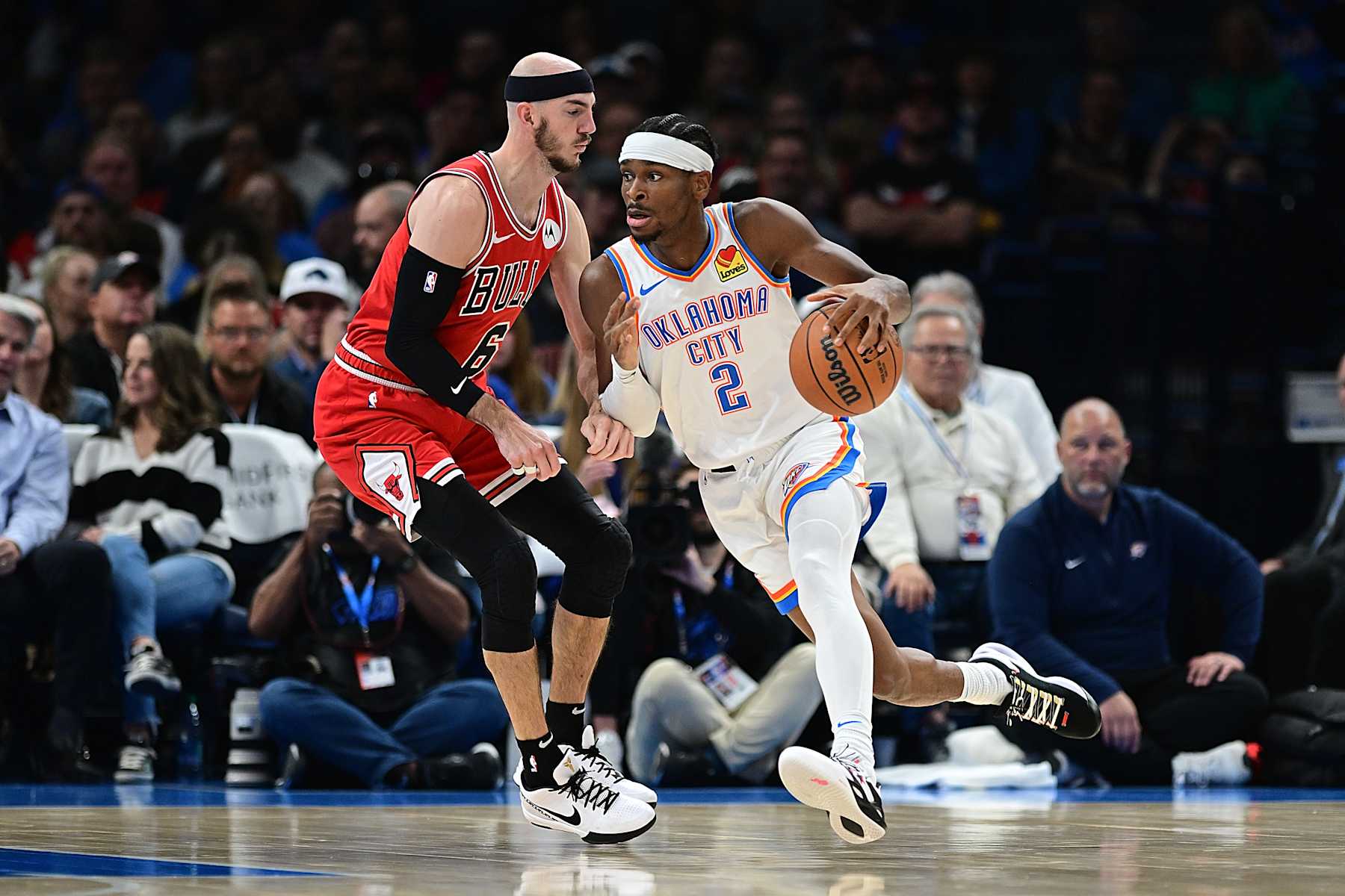OKLAHOMA CITY, OKLAHOMA - NOVEMBER 22: Shai Gilgeous-Alexander #2 of the Oklahoma City Thunder attempts to drive past Alex Caruso #6 of the Chicago Bulls during the first half at Paycom Center on November 22, 2023 in Oklahoma City, Oklahoma. NOTE TO USER: User expressly acknowledges and agrees that, by downloading and or using this Photograph, user is consenting to the terms and conditions of the Getty Images License Agreement. (Photo by Joshua Gateley/Getty Images)