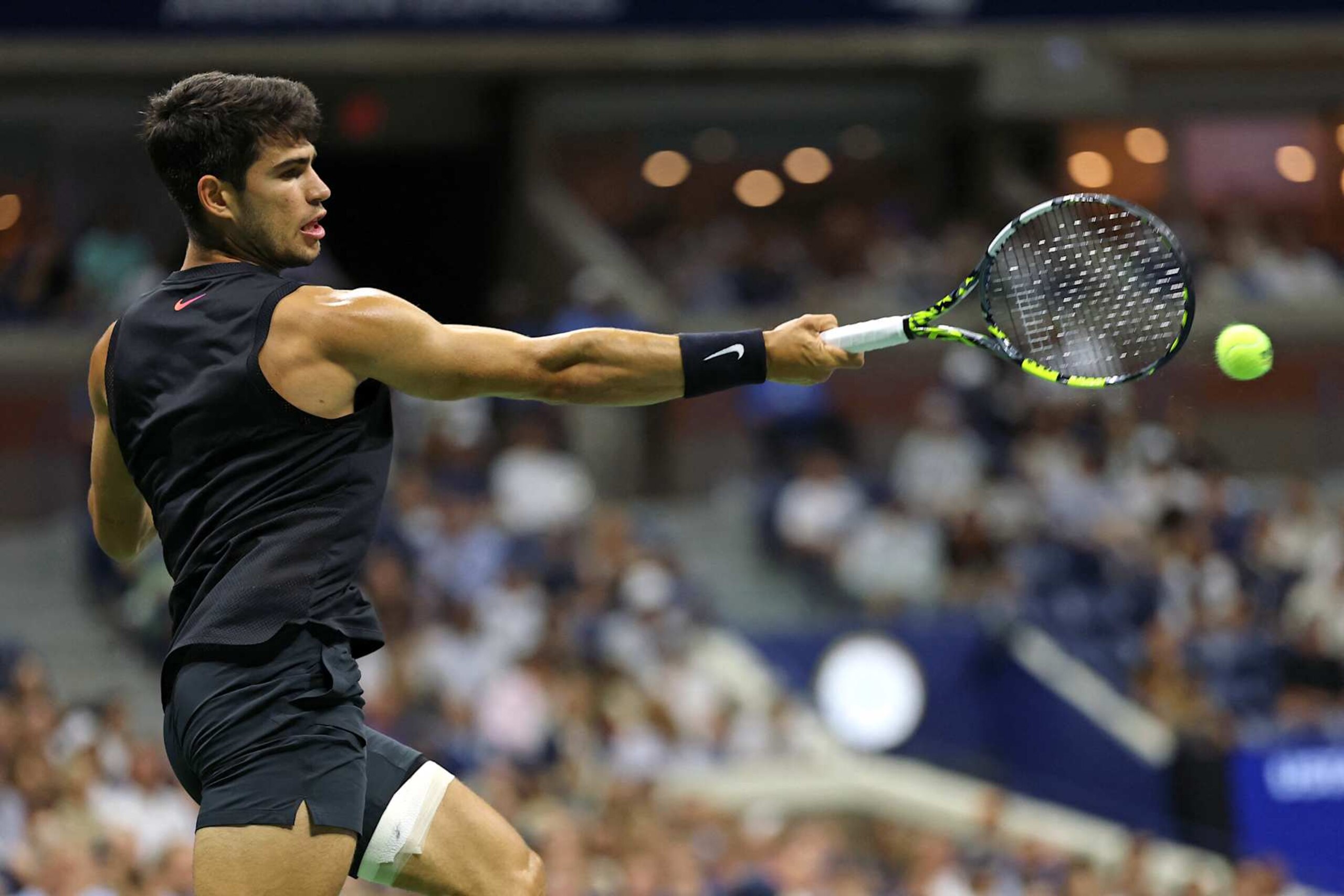 Spain's Carlos Alcaraz plays a forehand return against Netherlands' Botic van De Zandschulp during their men's singles second round tennis match on day four of the US Open tennis tournament at the USTA Billie Jean King National Tennis Center in New York City, on August 29, 2024. (Photo by CHARLY TRIBALLEAU / AFP) (Photo by CHARLY TRIBALLEAU/AFP via Getty Images)