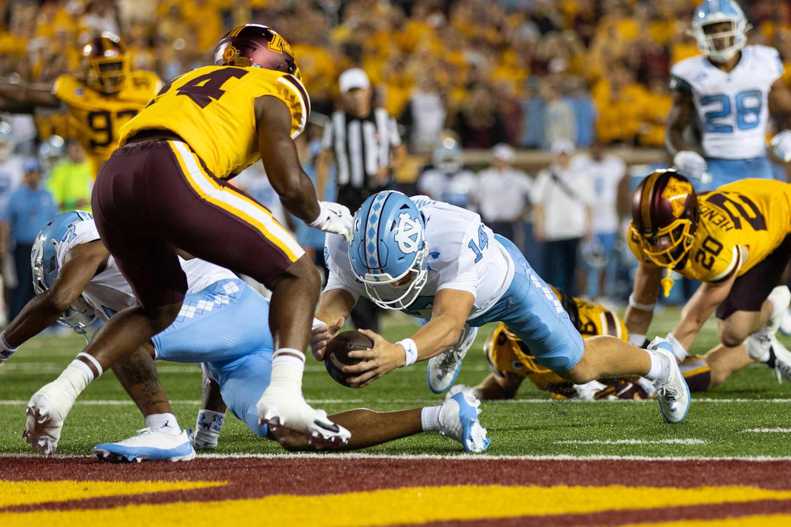 MINNEAPOLIS, MN - AUGUST 29: North Carolina Tar Heels quarterback Max Johnson (14) dives for a touchdown during the college football game between North Carolina Tar Heels and the Minnesota Golden Gophers on August 29, 2024, at Huntington Bank Stadium in Minneapolis, MN. (Photo by Bailey Hillesheim/Icon Sportswire via Getty Images) MINNEAPOLIS, MN - AUGUST 29: North Carolina Tar Heels quarterback Max Johnson (14) dives for a touchdown during the college football game between North Carolina Tar Heels and the Minnesota Golden Gophers on August 29, 2024, at Huntington Bank Stadium in Minneapolis, MN. (Photo by Bailey Hillesheim/Icon Sportswire via Getty Images)