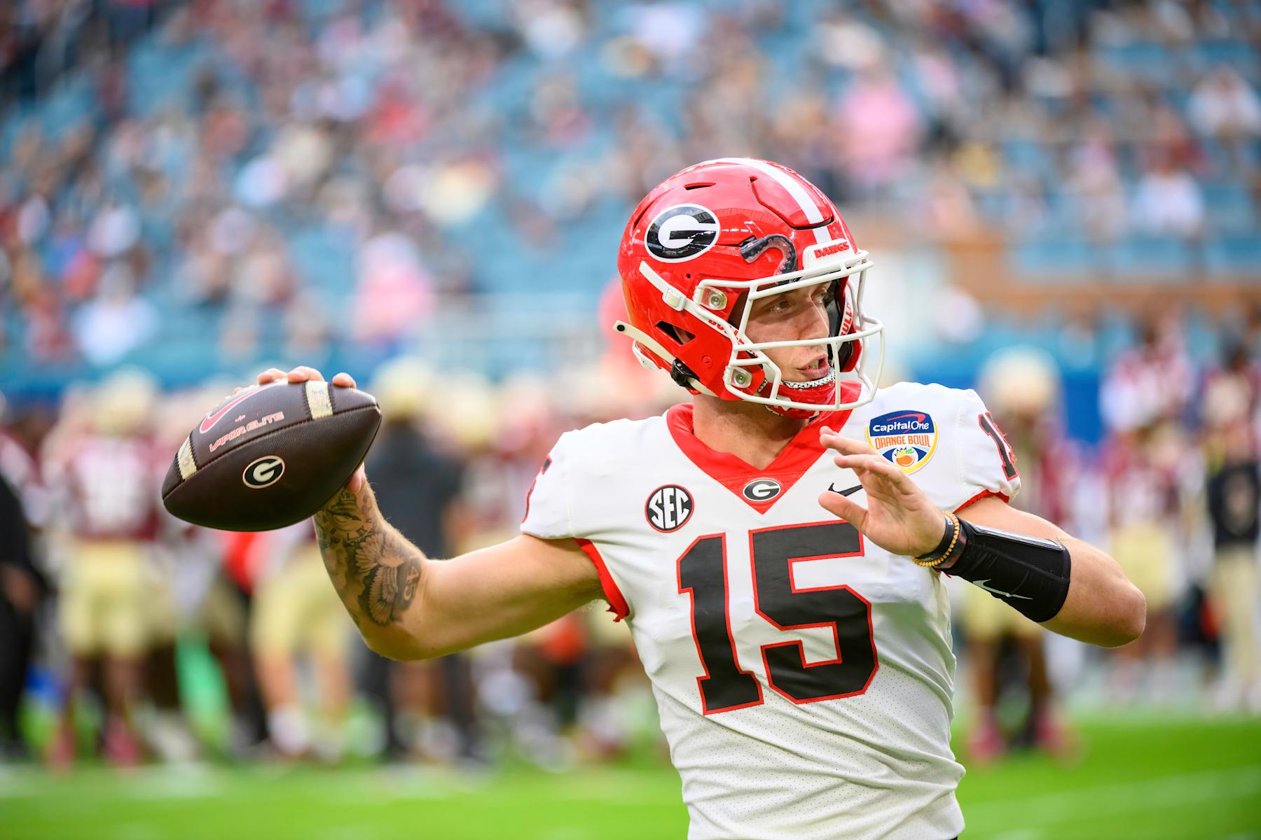 MIAMI GARDENS, FL - DECEMBER 30: Georgia quarterback Carson Beck (15) throws the football on the field as he warms up during the Capital One Orange Bowl college football game between the Georgia Bulldogs and the Florida State Seminoles on December 30, 2023 at the Hard Rock Stadium in Miami Gardens, FL. (Photo by Doug Murray/Icon Sportswire via Getty Images)
