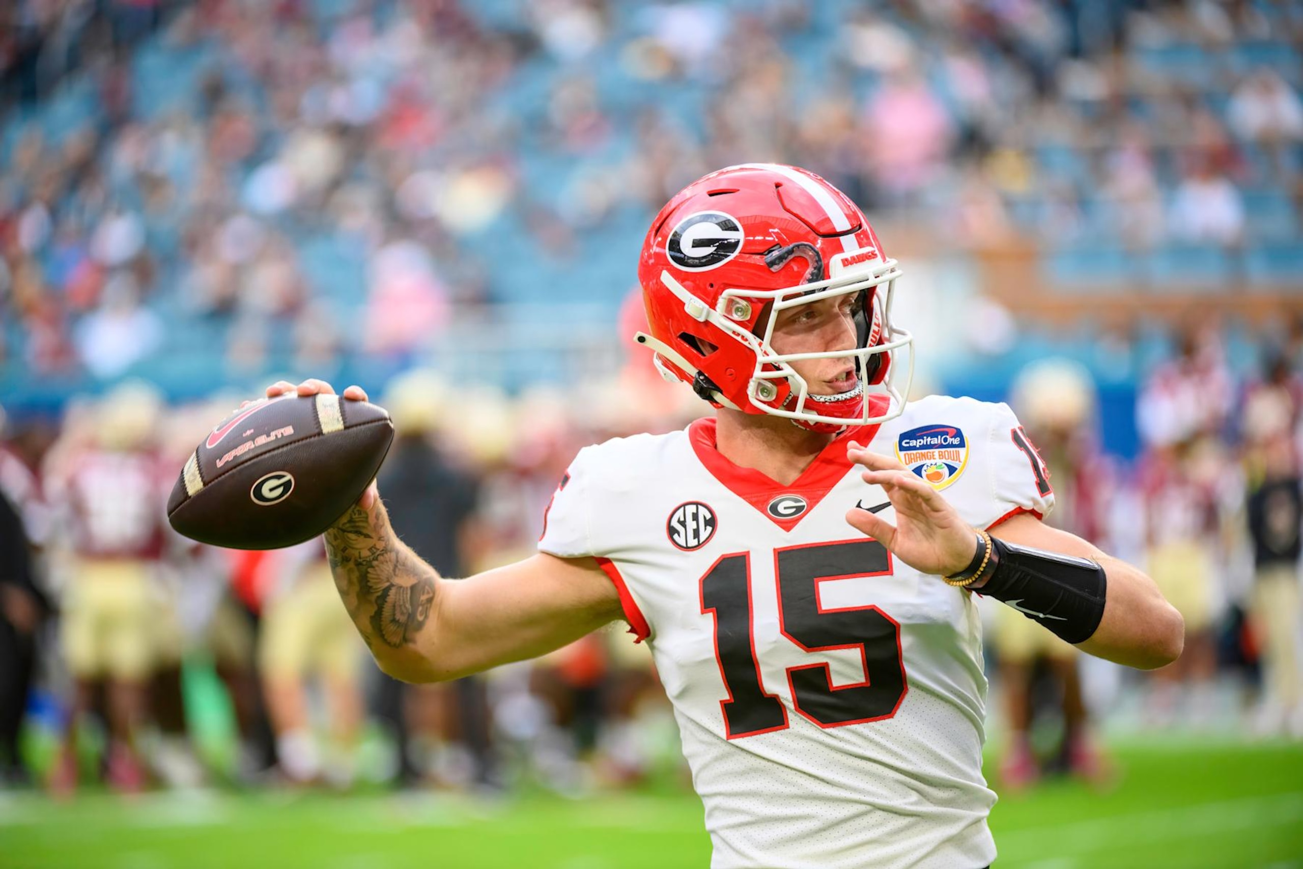 MIAMI GARDENS, FL - DECEMBER 30: Georgia quarterback Carson Beck (15) throws the football on the field as he warms up during the Capital One Orange Bowl college football game between the Georgia Bulldogs and the Florida State Seminoles on December 30, 2023 at the Hard Rock Stadium in Miami Gardens, FL. (Photo by Doug Murray/Icon Sportswire via Getty Images)