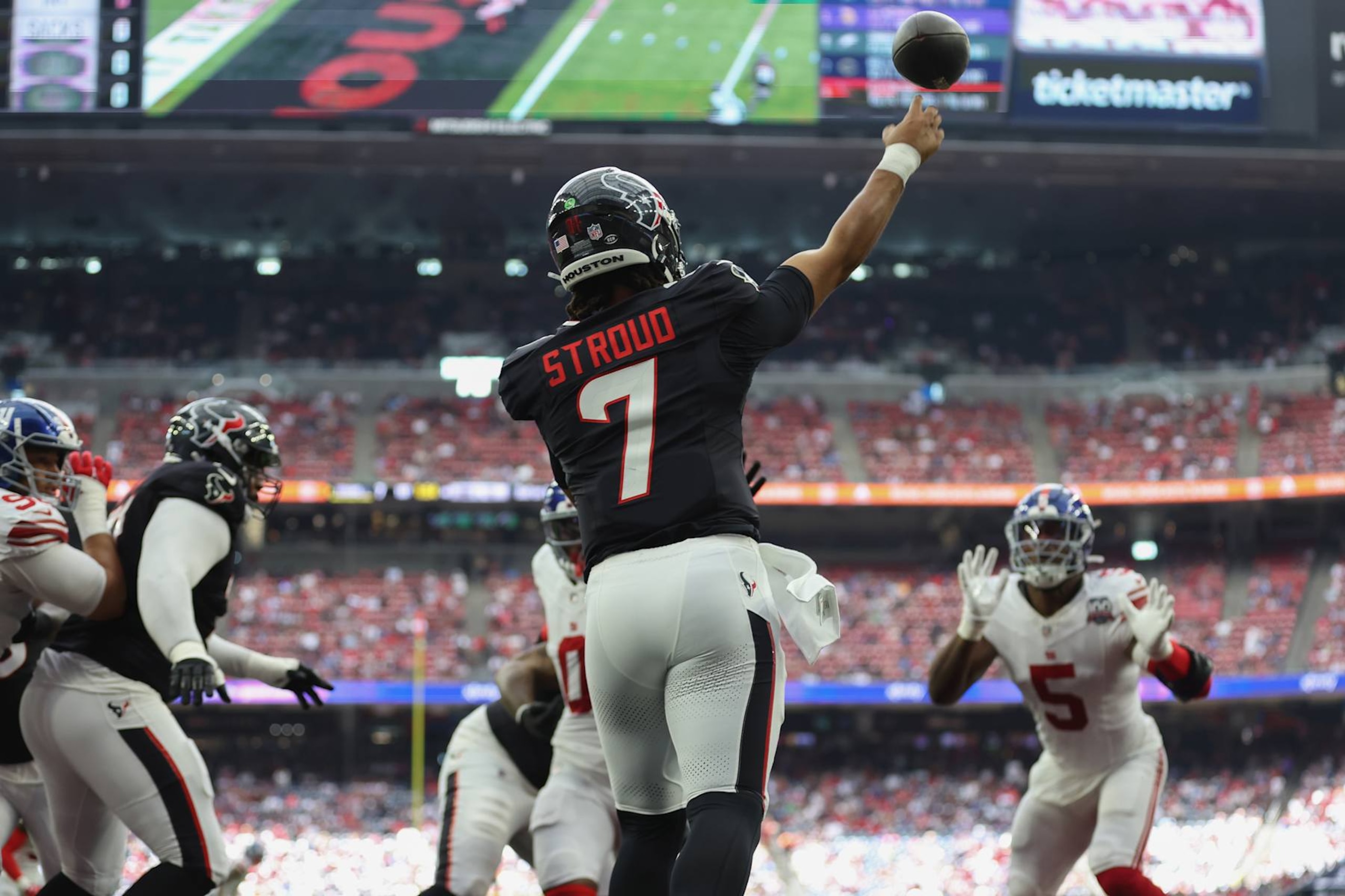 HOUSTON, TEXAS - AUGUST 17: C.J. Stroud #7 of the Houston Texans throws a pass from his end zone in the first quarter against the New York Giants during the preseason game at NRG Stadium on August 17, 2024 in Houston, Texas. (Photo by Tim Warner/Getty Images)