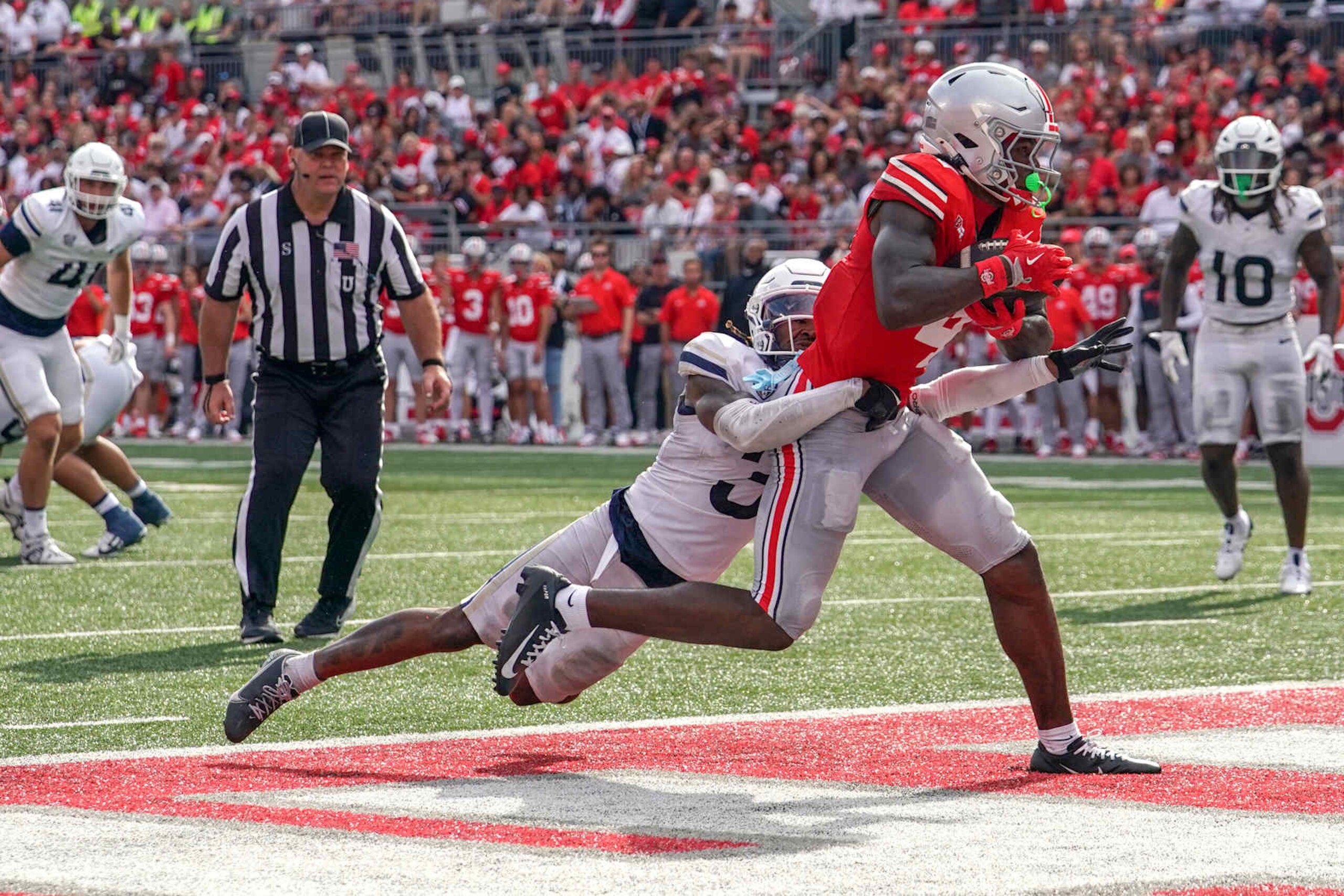 COLUMBUS, OHIO - AUGUST 31: Wide receiver Jeremiah Smith #4 of the Ohio State Buckeyes scores a touchdown during the second quarter against the Akron Zips at Ohio Stadium on August 31, 2024 in Columbus, Ohio. (Photo by Jason Mowry/Getty Images) COLUMBUS, OHIO - AUGUST 31: Wide receiver Jeremiah Smith #4 of the Ohio State Buckeyes scores a touchdown during the second quarter against the Akron Zips at Ohio Stadium on August 31, 2024 in Columbus, Ohio. (Photo by Jason Mowry/Getty Images)