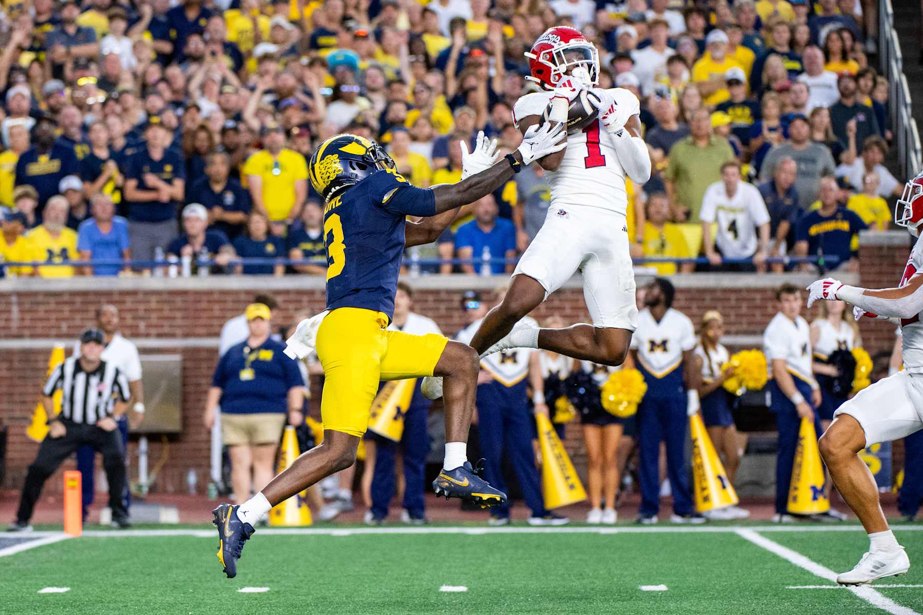 ANN ARBOR, MICHIGAN - AUGUST 31: Cam Lockridge #1 of the Fresno St. Bulldogs intercepts the ball intended for Fredrick Moore #3 of the Michigan Wolverines during the first half of a college football game at Michigan Stadium on August 31, 2024 in Ann Arbor, Michigan. (Photo by Aaron J. Thornton/Getty Images)