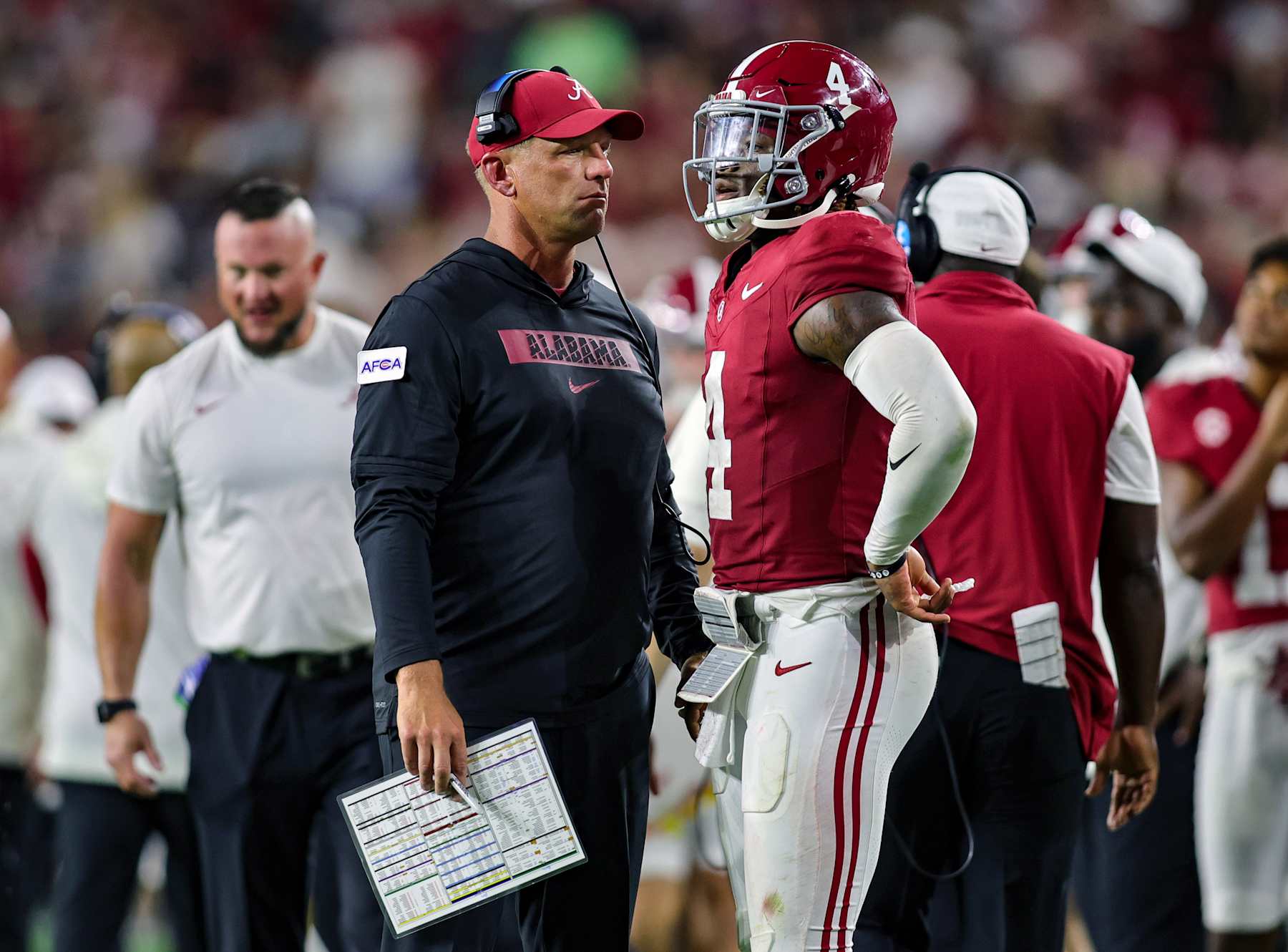 TUSCALOOSA, ALABAMA - AUGUST 31: Head coach Kalen DeBoer and Jalen Milroe #4 of the Alabama Crimson Tide talk during the second half against the Western Kentucky Hilltoppers at Bryant-Denny Stadium on August 31, 2024 in Tuscaloosa, Alabama. (Photo by Brandon Sumrall/Getty Images)