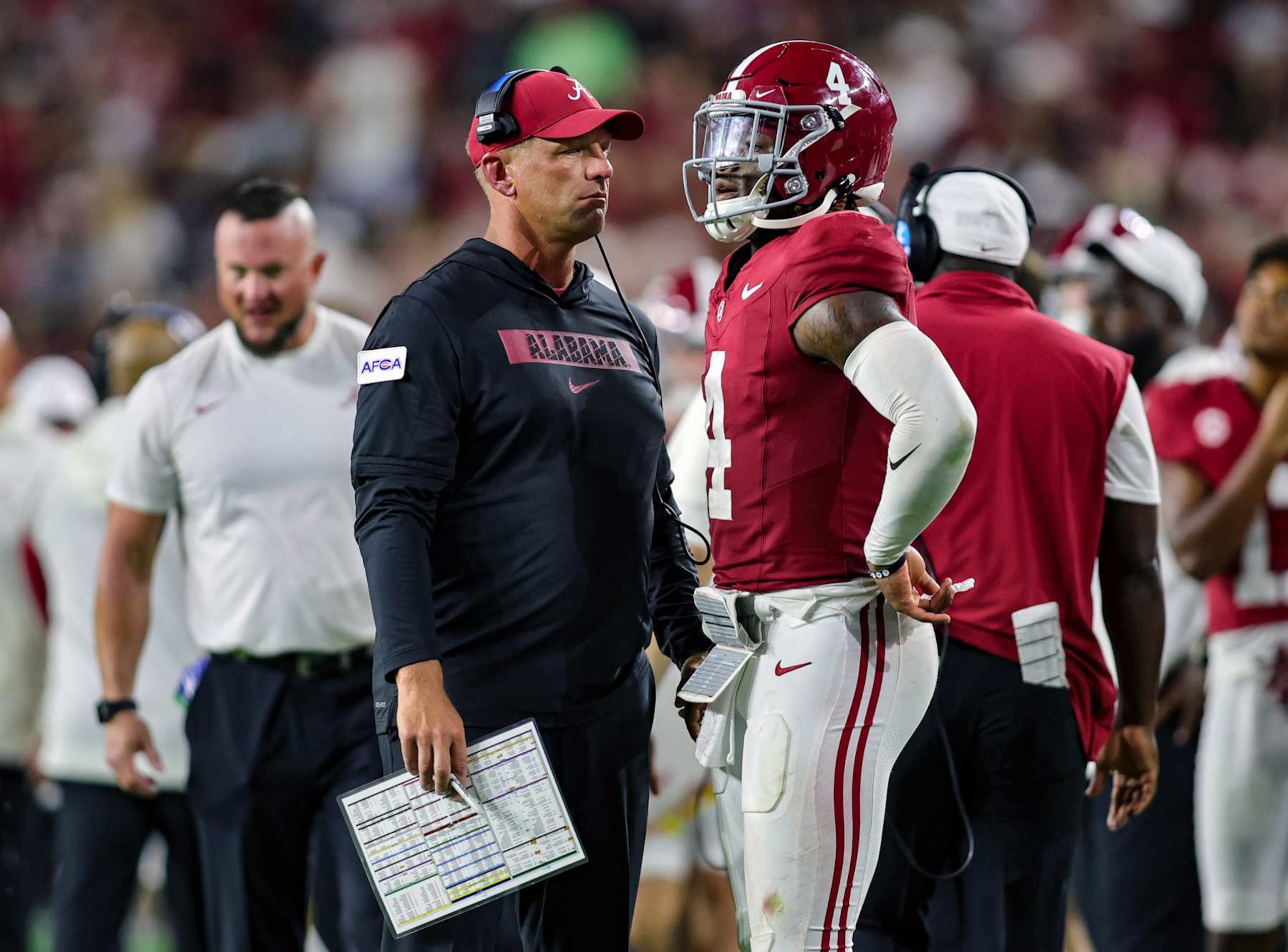 TUSCALOOSA, ALABAMA - AUGUST 31: Head coach Kalen DeBoer and Jalen Milroe #4 of the Alabama Crimson Tide talk during the second half against the Western Kentucky Hilltoppers at Bryant-Denny Stadium on August 31, 2024 in Tuscaloosa, Alabama. (Photo by Brandon Sumrall/Getty Images) TUSCALOOSA, ALABAMA - AUGUST 31: Head coach Kalen DeBoer and Jalen Milroe #4 of the Alabama Crimson Tide talk during the second half against the Western Kentucky Hilltoppers at Bryant-Denny Stadium on August 31, 2024 in Tuscaloosa, Alabama. (Photo by Brandon Sumrall/Getty Images)
