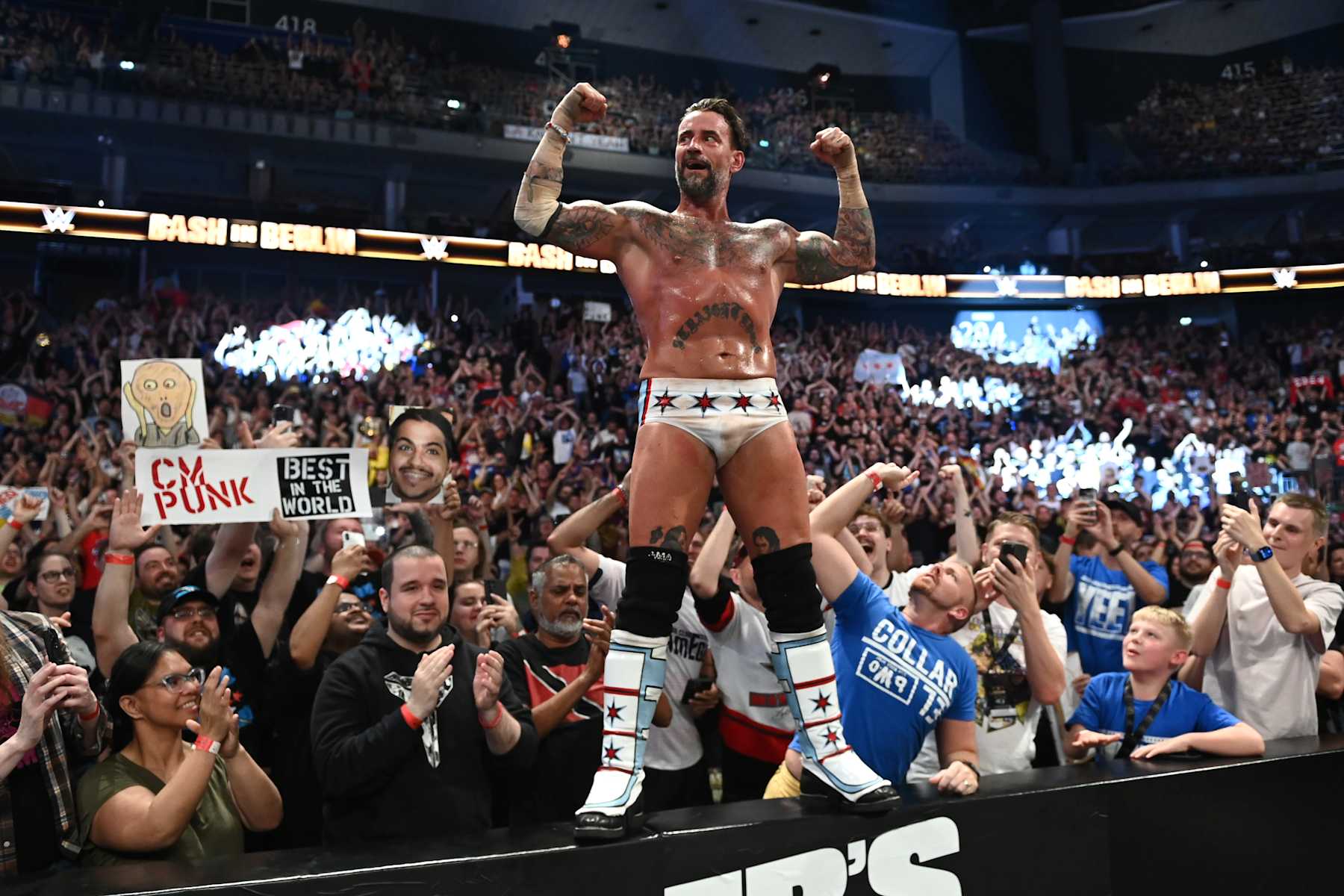 BERLIN, GERMANY - AUGUST 31: CM Punk celebrates his victory over Drew McIntyre (not pictured) with fans following their strap match at the WWE Bash in Berlin Premium Live Event at Uber Arena on August 31, 2024 in Berlin, Germany.  (Photo by WWE/Getty Images)