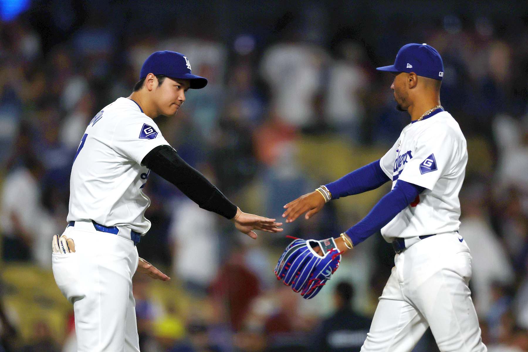 LOS ANGELES, CALIFORNIA - AUGUST 29: Shohei Ohtani #17 and Mookie Betts #50 of the Los Angeles Dodgers celebrate their 6-3 win against the Baltimore Orioles after the game at Dodger Stadium on August 29, 2024 in Los Angeles, California. (Photo by Katelyn Mulcahy/Getty Images)
