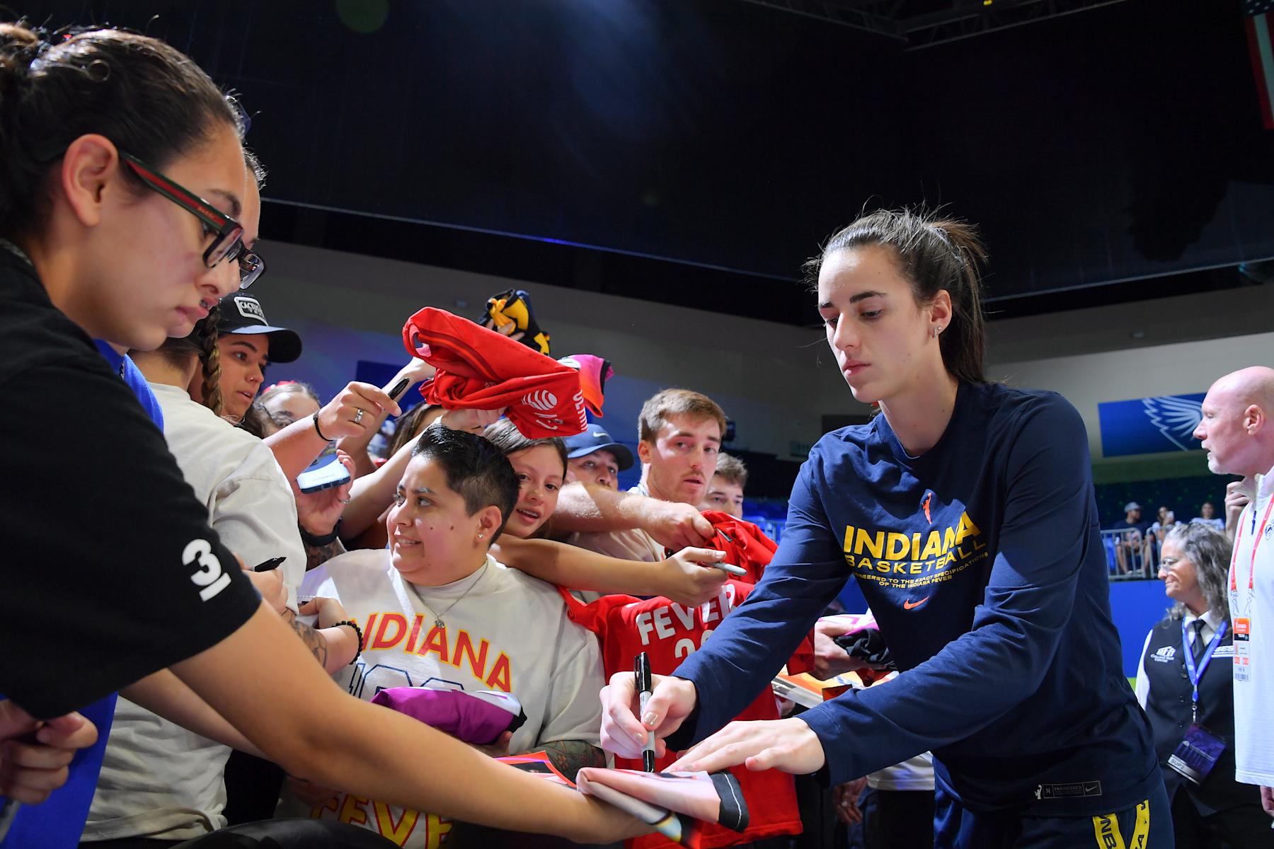 ARLINGTON, TX -  SEPTEMBER 1: Caitlin Clark #22 of the Indiana Fever signs fan gear before the game on September 1, 2024 at the College Park Center in Arlington, TX. NOTE TO USER: User expressly acknowledges and agrees that, by downloading and or using this photograph, User is consenting to the terms and conditions of the Getty Images License Agreement. Mandatory Copyright Notice: Copyright 2024 NBAE (Photo by Michael Gonzales/NBAE via Getty Images)