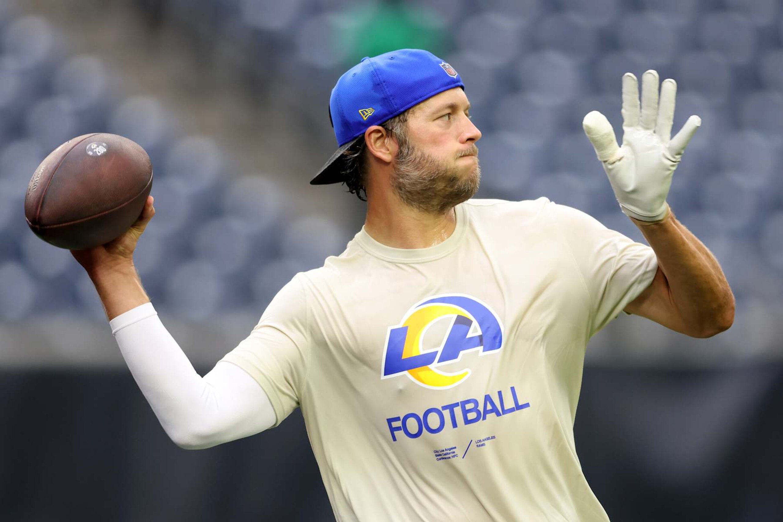 HOUSTON, TEXAS - AUGUST 24: Matthew Stafford #9 of the Los Angeles Rams warms up before the preseason game against the Houston Texans at NRG Stadium on August 24, 2024 in Houston, Texas.  (Photo by Tim Warner/Getty Images)