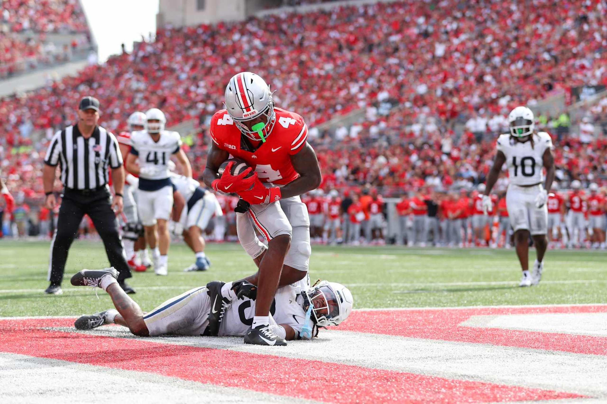 COLUMBUS, OH - AUGUST 31: Ohio State Buckeyes wide receiver Jeremiah Smith (4) scores a touchdown during the game against the Akron Zips and the Ohio State Buckeyes on August 31, 2024, at Ohio Stadium in Columbus, OH. (Photo by Ian Johnson/Icon Sportswire via Getty Images)