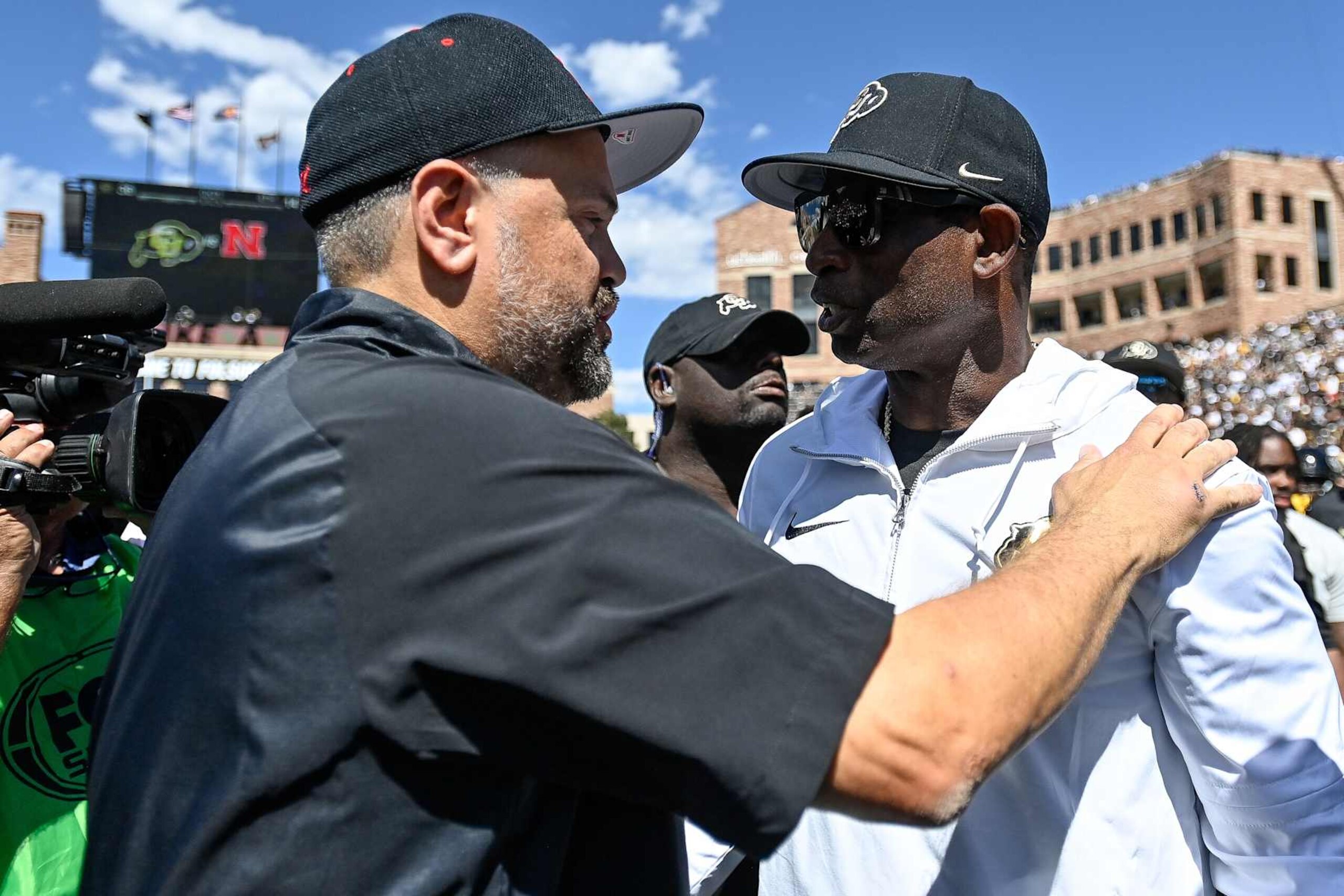 BOULDER, CO - SEPTEMBER 9: Head coach Matt Rhule of the Nebraska Cornhuskers and head coach Deion Sanders of the Colorado Buffaloes have a word after a Colorado Buffaloes win at Folsom Field on September 9, 2023 in Boulder, Colorado. (Photo by Dustin Bradford/Getty Images) BOULDER, CO - SEPTEMBER 9: Head coach Matt Rhule of the Nebraska Cornhuskers and head coach Deion Sanders of the Colorado Buffaloes have a word after a Colorado Buffaloes win at Folsom Field on September 9, 2023 in Boulder, Colorado. (Photo by Dustin Bradford/Getty Images)