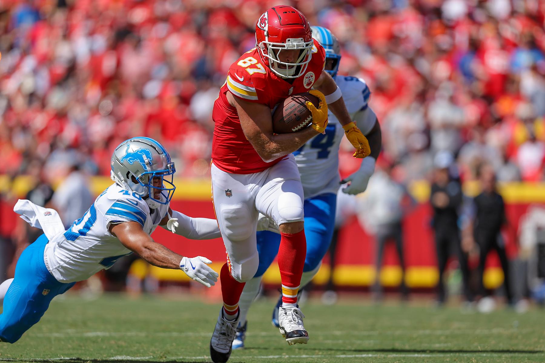 KANSAS CITY, MISSOURI - AUGUST 17: Travis Kelce #87 of the Kansas City Chiefs runs after a first quarter pass catch near Brandon Joseph #40 of the Detroit Lions during preseason game action at GEHA Field at Arrowhead Stadium on August 17, 2024 in Kansas City, Missouri. (Photo by David Eulitt/Getty Images)
