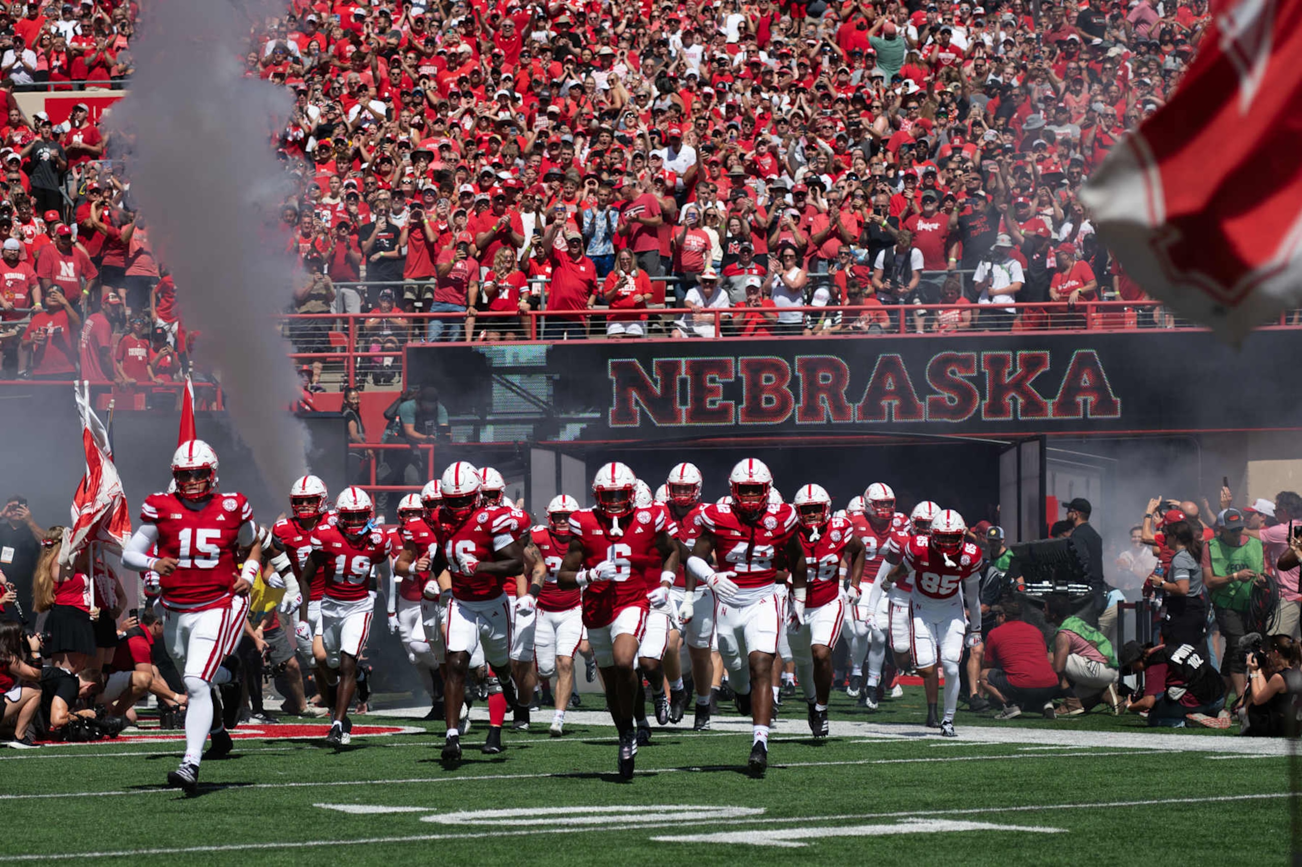 LINCOLN, NEBRASKA - AUGUST 31: Dylan Raiola #15 of the Nebraska Cornhuskers and Tommi Hill #6 lead the team onto the field before the game against the UTEP Miners at Memorial Stadium on August 31, 2024 in Lincoln, Nebraska. (Photo by Steven Branscombe/Getty Images)