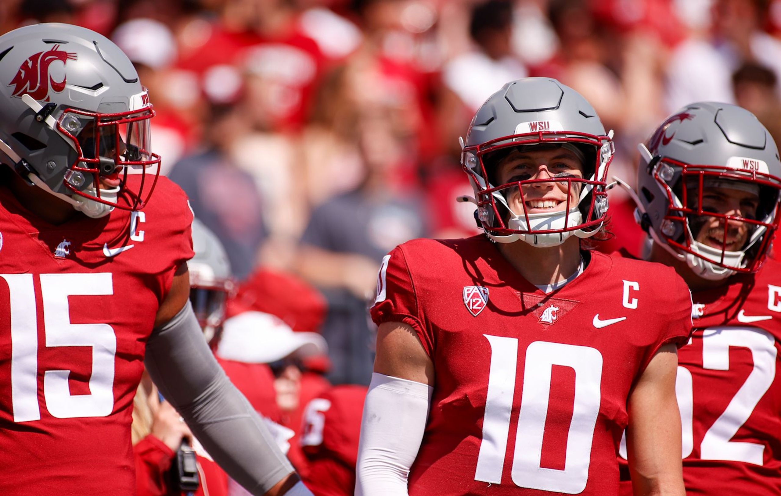 PULLMAN, WA - AUGUST 31: Washington State Cougars quarterback John Mateer (10) smiles as he joins the other team captains before the game between the Portland State Vikings and the Washington State Cougars on August 31, 2024, at Martin Stadium in Pullman, WA. (Photo by Oliver McKenna/Icon Sportswire via Getty Images)