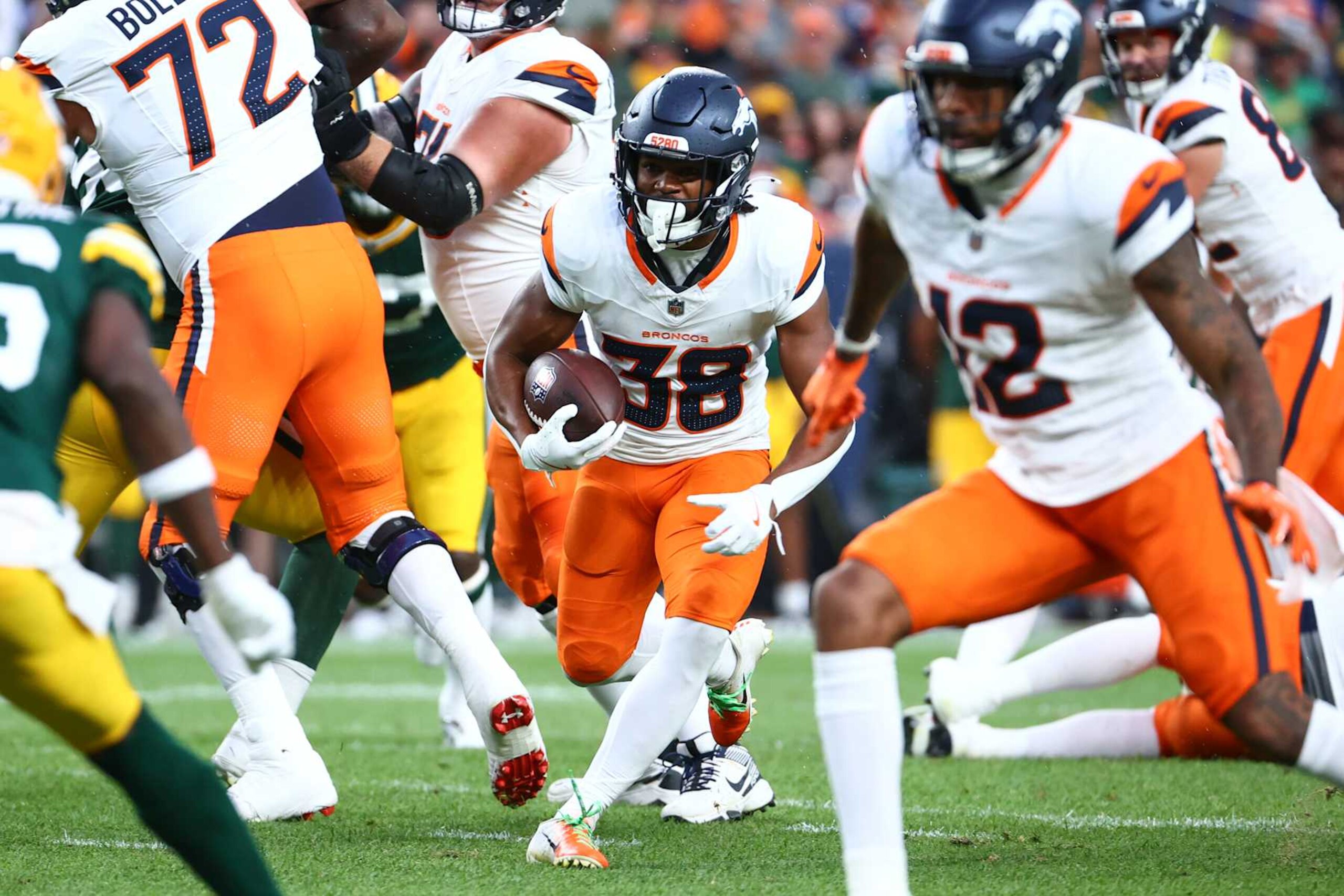 DENVER, COLORADO - AUGUST 18: Jaleel McLaughlin #38 of the Denver Broncos runs the ball in the first half during the preseason game against the Green Bay Packers at Empower Field At Mile High on August 18, 2024 in Denver, Colorado. (Photo by Tyler Schank/Getty Images)