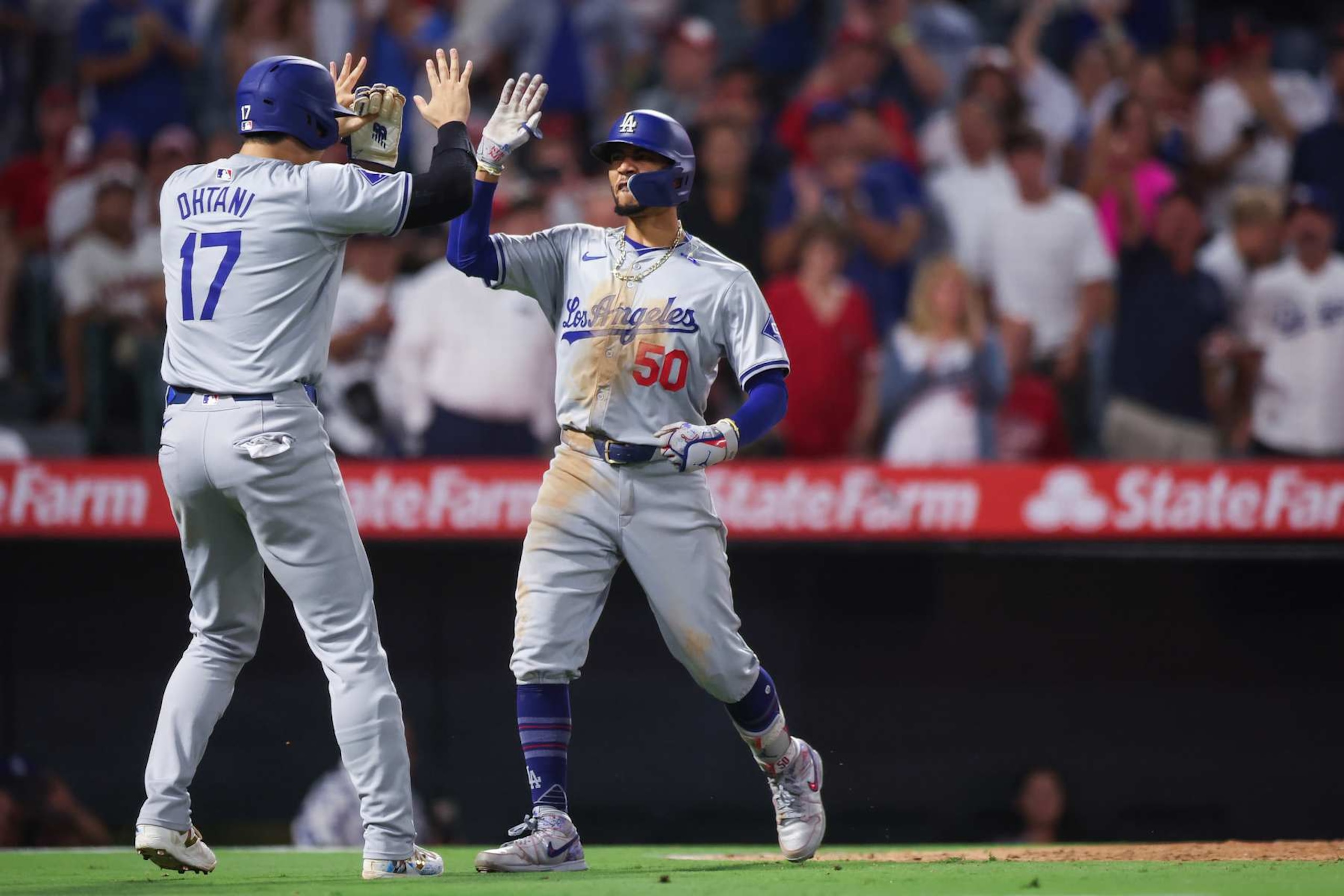 ANAHEIM, CALIFORNIA - SEPTEMBER 03: Mookie Betts #50 of the Los Angeles Dodgers reacts with Shohei Ohtani #17 after hitting a three run home run in the tenth inning against the Los Angeles Angels at Angel Stadium of Anaheim on September 03, 2024 in Anaheim, California. (Photo by Meg Oliphant/Getty Images) ANAHEIM, CALIFORNIA - SEPTEMBER 03: Mookie Betts #50 of the Los Angeles Dodgers reacts with Shohei Ohtani #17 after hitting a three run home run in the tenth inning against the Los Angeles Angels at Angel Stadium of Anaheim on September 03, 2024 in Anaheim, California. (Photo by Meg Oliphant/Getty Images)