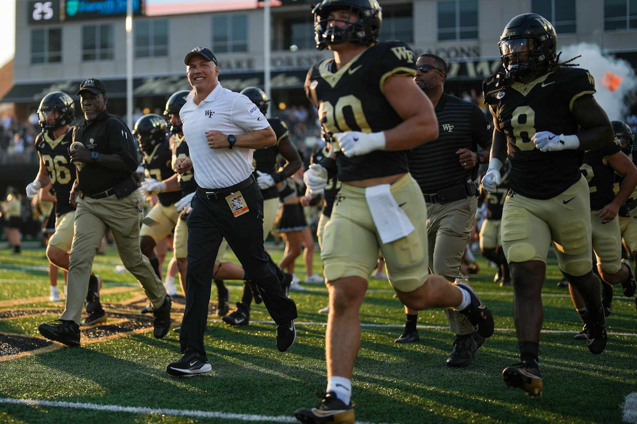 WINSTON-SALEM, NORTH CAROLINA - AUGUST 29: Head coach Dave Clawson of the Wake Forest Demon Deacons leads his team onto the field during their game against the North Carolina A&T Aggies at Truist Field on August 29, 2024 in Winston-Salem, North Carolina. (Photo by Grant Halverson/Getty Images) WINSTON-SALEM, NORTH CAROLINA - AUGUST 29: Head coach Dave Clawson of the Wake Forest Demon Deacons leads his team onto the field during their game against the North Carolina A&T Aggies at Truist Field on August 29, 2024 in Winston-Salem, North Carolina. (Photo by Grant Halverson/Getty Images)