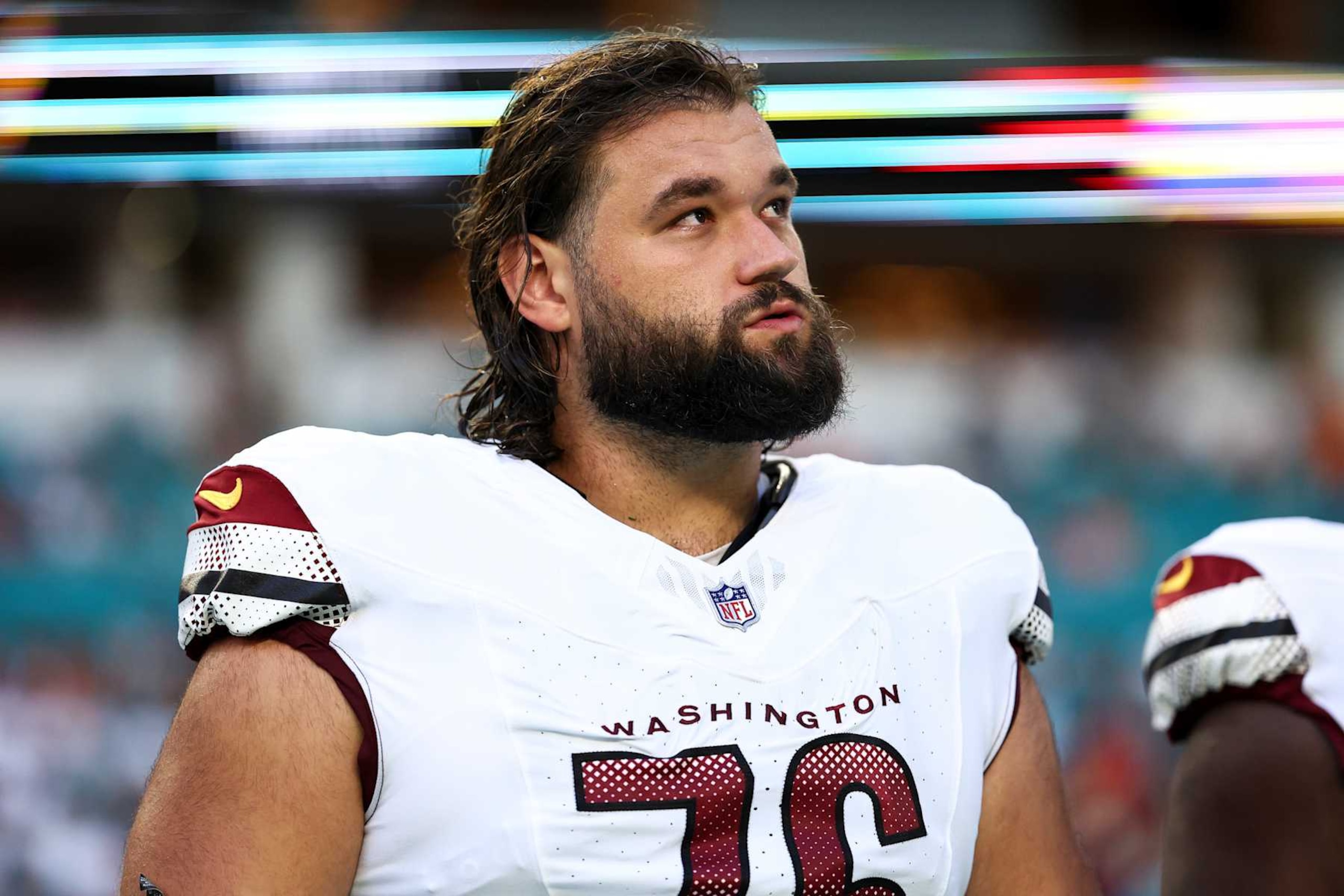 MIAMI GARDENS, FL - AUGUST 17: Sam Cosmi #76 of the Washington Commanders stands on the sidelines during the national anthem prior to an NFL preseason football game against the Miami Dolphins at Hard Rock Stadium on August 17, 2024 in Miami Gardens, FL. (Photo by Kevin Sabitus/Getty Images)