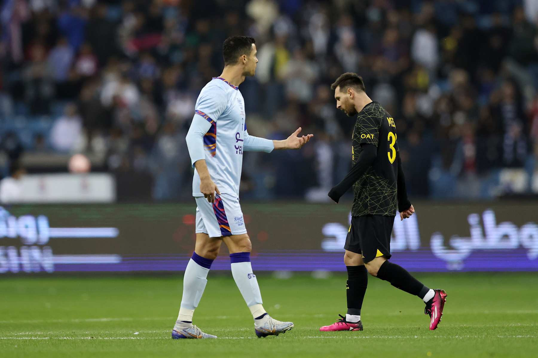 RIYADH, SAUDI ARABIA - JANUARY 19: Lionel Messi of Paris Saint-Germain walks past Cristiano Ronaldo of Riyadh XI after scoring the side's first goal during the Winter Tour 2023 friendly between Paris Saint-Germain and Riyadh XI at King Fahd International Stadium on January 19, 2023 in Riyadh, Saudi Arabia. (Photo by Yasser Bakhsh/Getty Images)