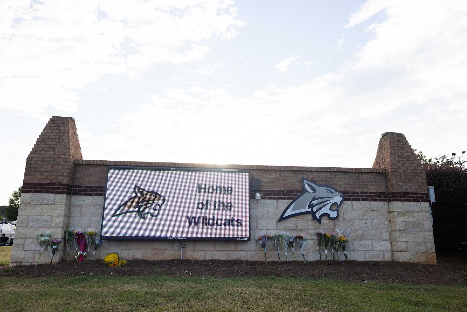 WINDER, GEORGIA - SEPTEMBER 5: Flowers lay at the school sign of Apalachee High School on September 5, 2024 in Winder, Georgia. Two students and two teachers were shot and killed at the school on September 4, and a 14-year-old suspect, who is a student at the school, is in custody.  (Photo by Jessica McGowan/Getty Images)