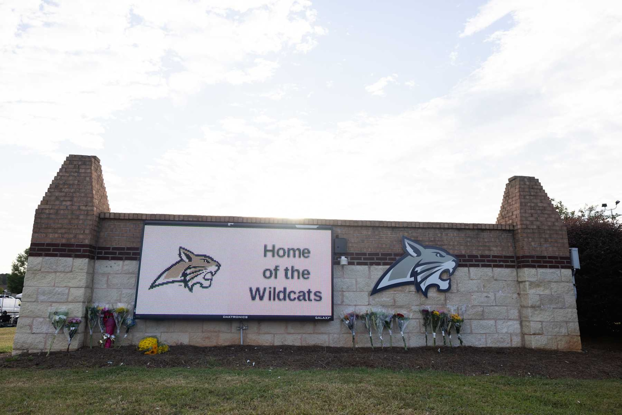 WINDER, GEORGIA - SEPTEMBER 5: Flowers lay at the school sign of Apalachee High School on September 5, 2024 in Winder, Georgia. Two students and two teachers were shot and killed at the school on September 4, and a 14-year-old suspect, who is a student at the school, is in custody.  (Photo by Jessica McGowan/Getty Images)