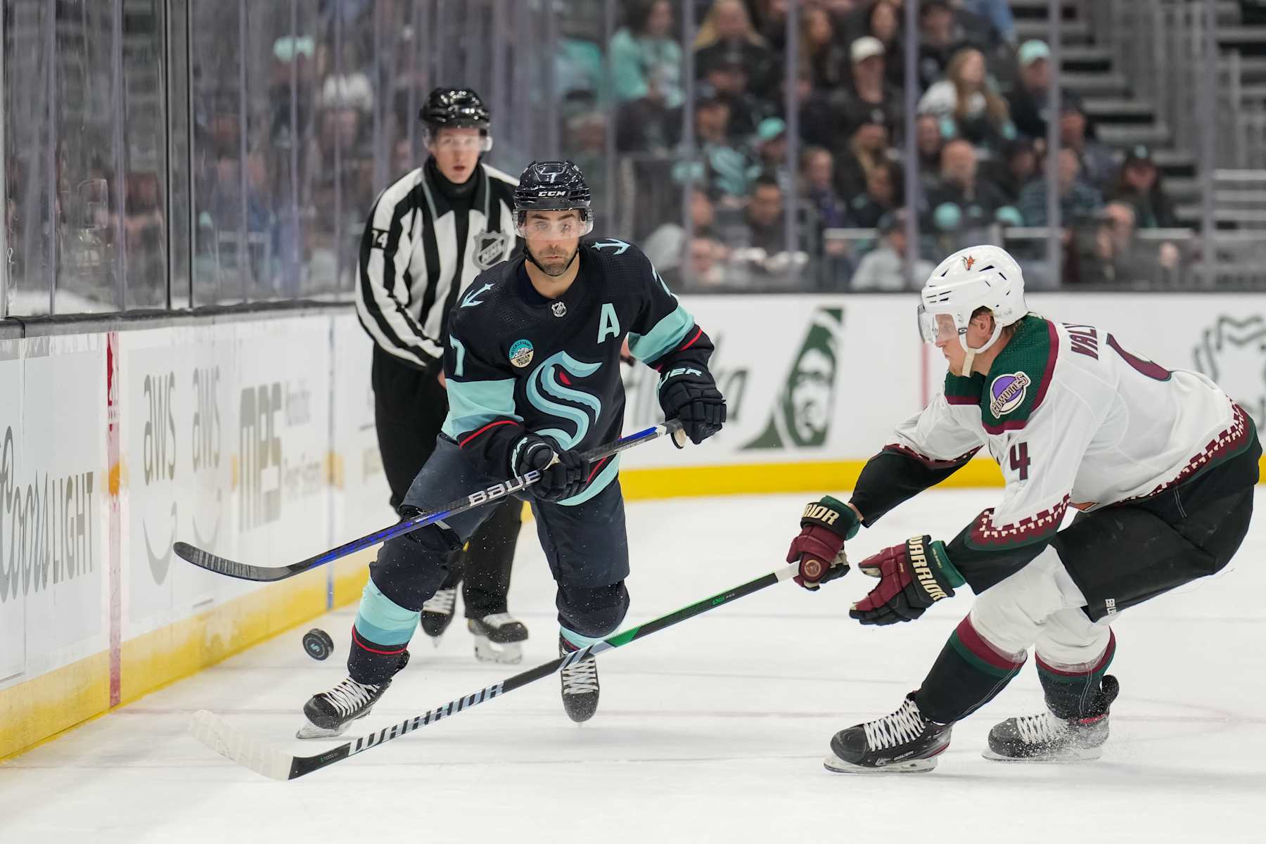 SEATTLE, WASHINGTON - APRIL 09: Jordan Eberle #7 of the Seattle Kraken chips the puck into the offensive zone during the first period of a game against the Arizona Coyotes at Climate Pledge Arena on April 09, 2024 in Seattle, Washington. (Photo by Christopher Mast/NHLI via Getty Images)