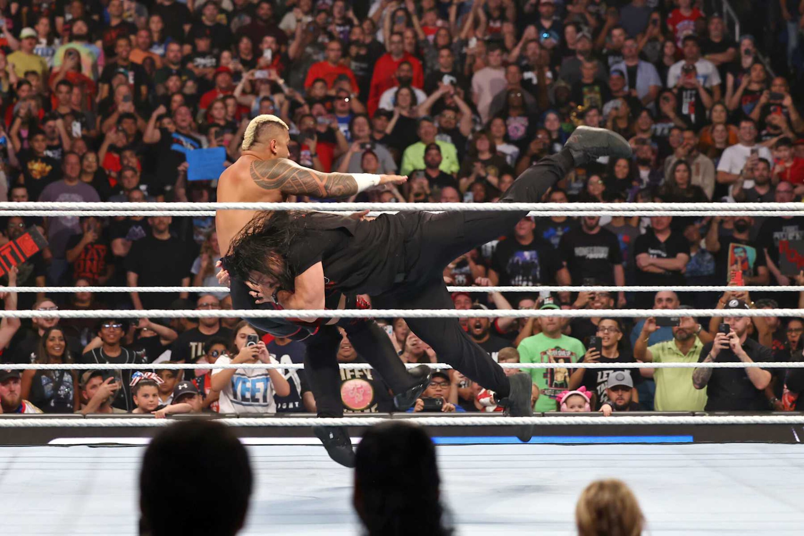 ORLANDO, FLORIDA - AUGUST 16: Roman Reigns spears Solo Sikoa during WWE Friday Night SmackDown on Fox at Kia Center on August 16, 2024 in Orlando, Florida.  (Photo by WWE/Getty Images)