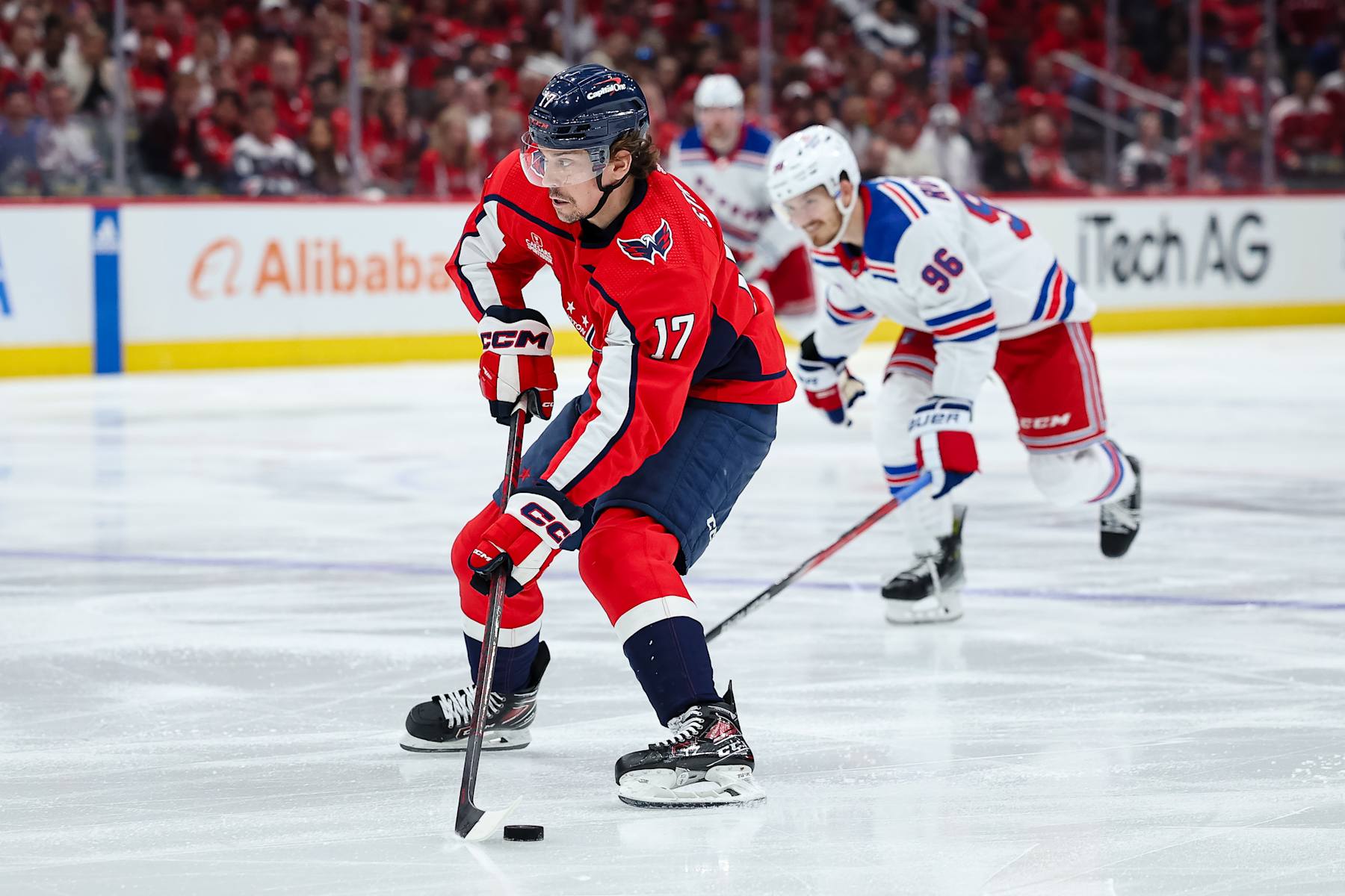 WASHINGTON, DC - APRIL 28: Dylan Strome #17 of the Washington Capitals skates with the puck in front of Jack Roslovic #96 of the New York Rangers during the second period in Game Four of the First Round of the 2024 Stanley Cup Playoffs at Capital One Arena on April 28, 2024 in Washington, DC. (Photo by Scott Taetsch/Getty Images)