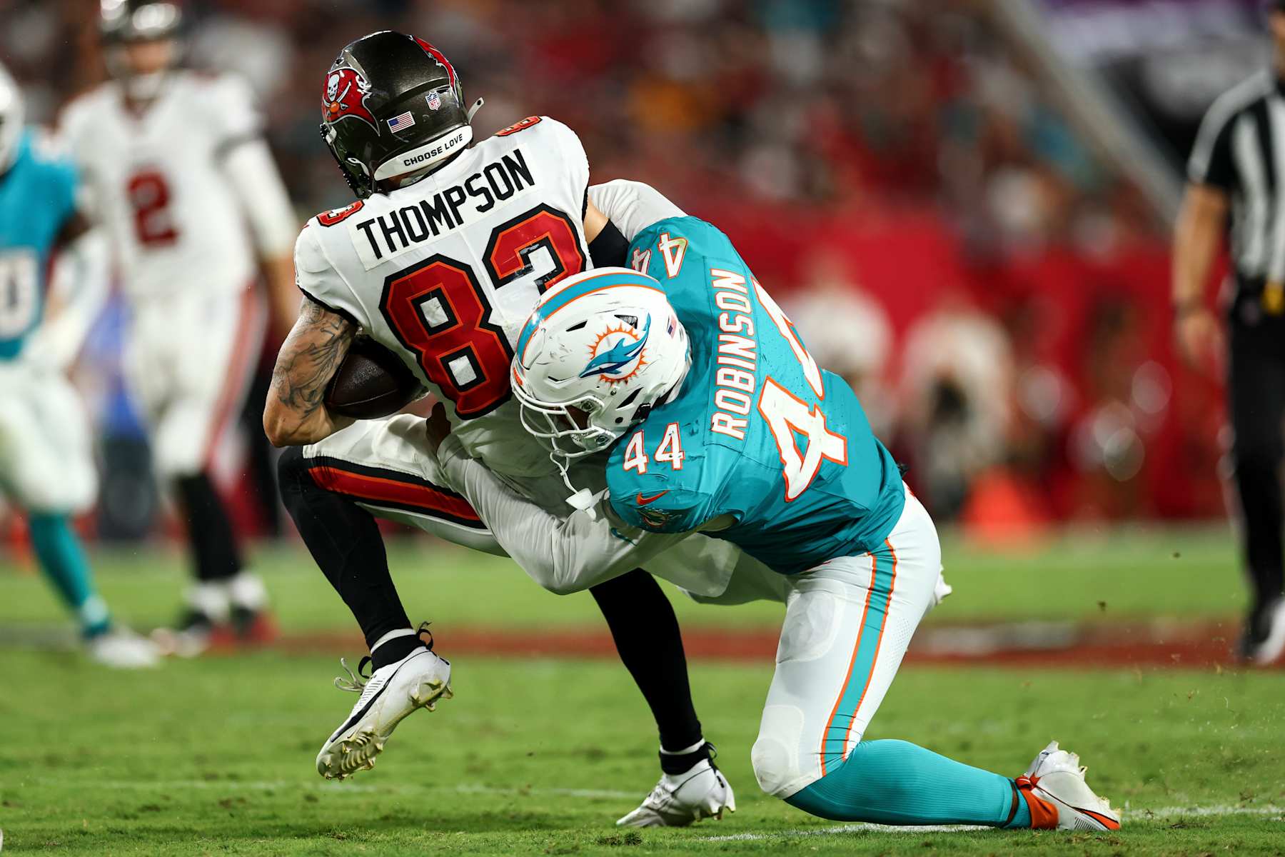 TAMPA, FL - AUGUST 23: Chop Robinson #44 of the Miami Dolphins tackles Cody Thompson #83 of the Tampa Bay Buccaneers during the second quarter of an NFL preseason football game at Raymond James Stadium on August 23, 2024 in Tampa, FL. (Photo by Kevin Sabitus/Getty Images)