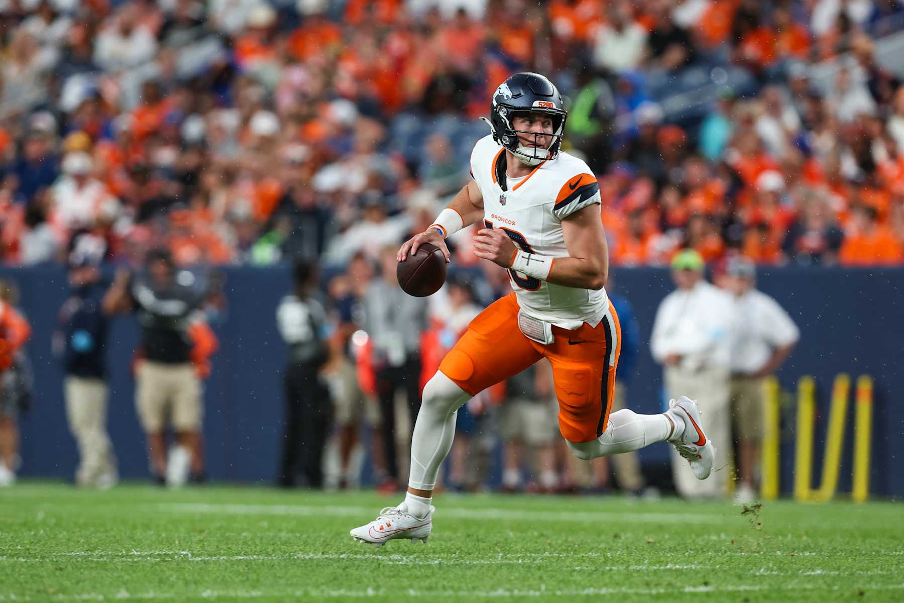 DENVER, CO - AUGUST 18: Bo Nix #10 of the Denver Broncos scrambles out of the pocket during an NFL football game against the Green Bay Packers at Empower Field at Mile High on August 18, 2024 in Denver, CO. (Photo by Perry Knotts/Getty Images)