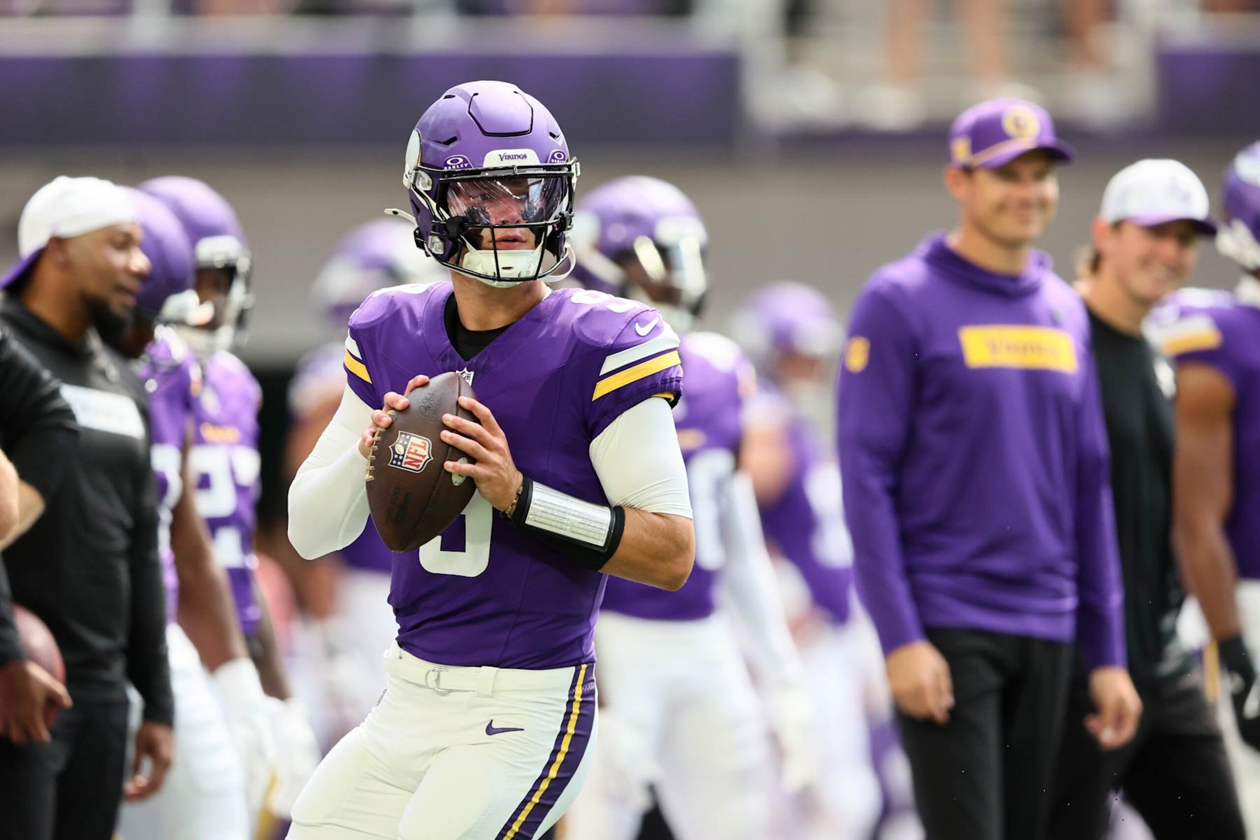 MINNEAPOLIS, MINNESOTA - AUGUST 10: Minnesota Vikings head coach Kevin OConnell watches J.J. McCarthy #9 of the Minnesota Vikings warm up before the pre-season game against Las Vegas Raiders at U.S. Bank Stadium on August 10, 2024 in Minneapolis, Minnesota. J.J. McCarthys season was cut short due to a knee injury in the preseason game. (Photo by Adam Bettcher/Getty Images)