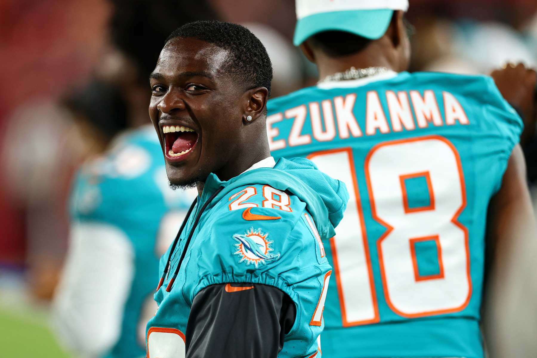 TAMPA, FL - AUGUST 23: De'Von Achane #28 of the Miami Dolphins smiles on the sidelines during the second quarter of an NFL preseason football game against the Tampa Bay Buccaneers at Raymond James Stadium on August 23, 2024 in Tampa, Florida. (Photo by Kevin Sabitus/Getty Images)