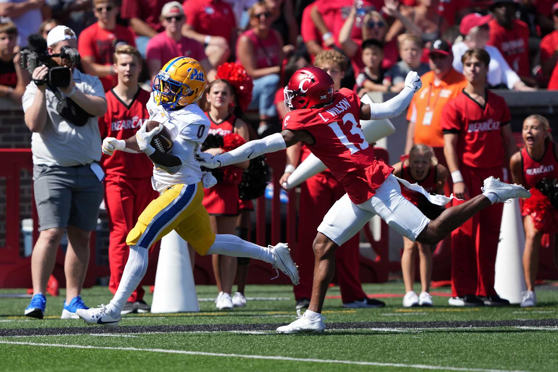 CINCINNATI, OHIO - SEPTEMBER 07: Desmond Reid #0 of the Pittsburgh Panthers runs with the ball while being chased by Logan Wilson #13 of the Cincinnati Bearcats in the fourth quarter at Nippert Stadium on September 07, 2024 in Cincinnati, Ohio. (Photo by Dylan Buell/Getty Images)