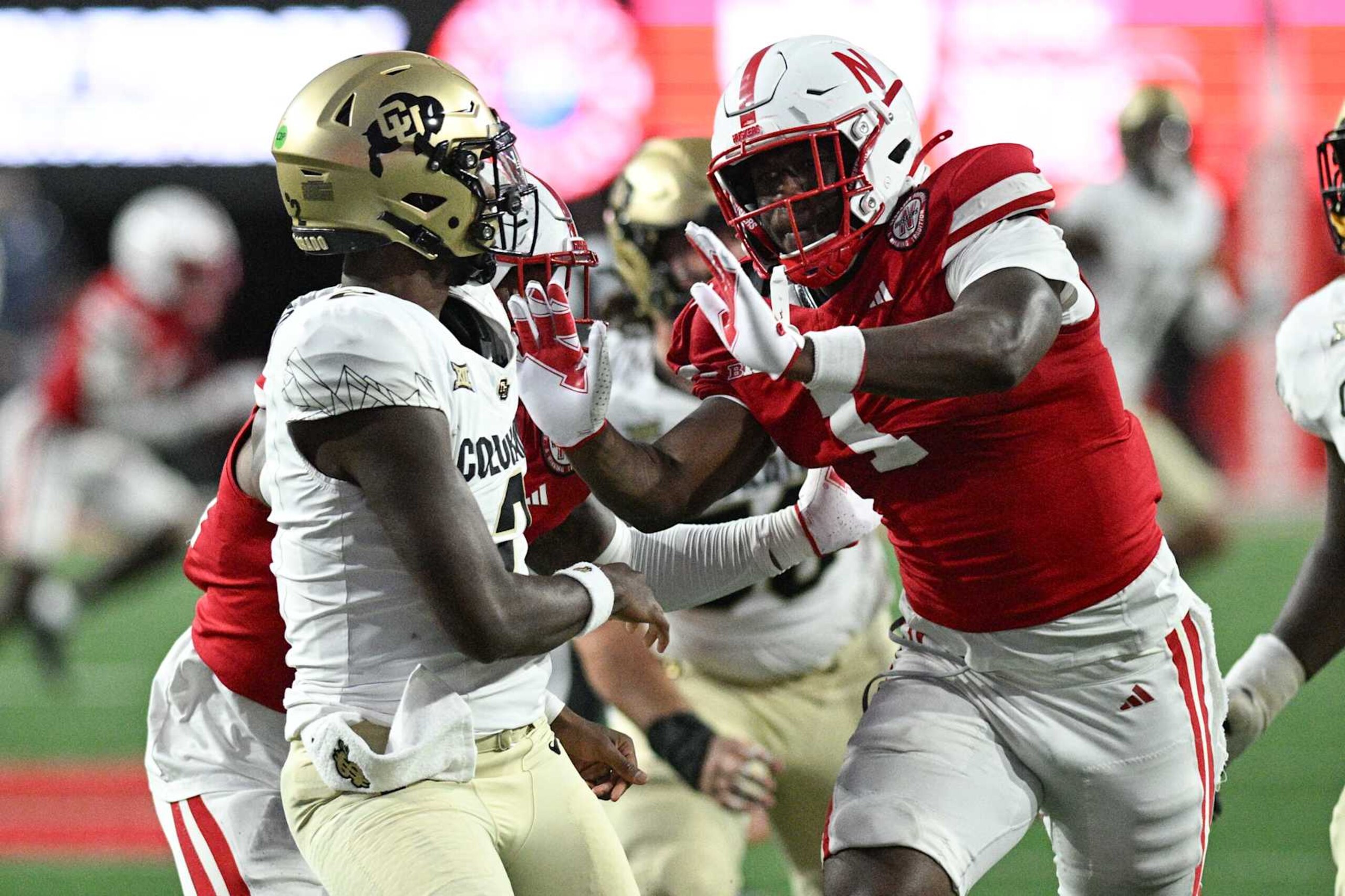 LINCOLN, NEBRASKA - SEPTEMBER 07: Jimari Butler #1 of the Nebraska Cornhuskers rushes against Shedeur Sanders #2 of the Colorado Buffaloes during the second quarter at Memorial Stadium on September 7, 2024 in Lincoln, Nebraska. (Photo by Steven Branscombe/Getty Images)