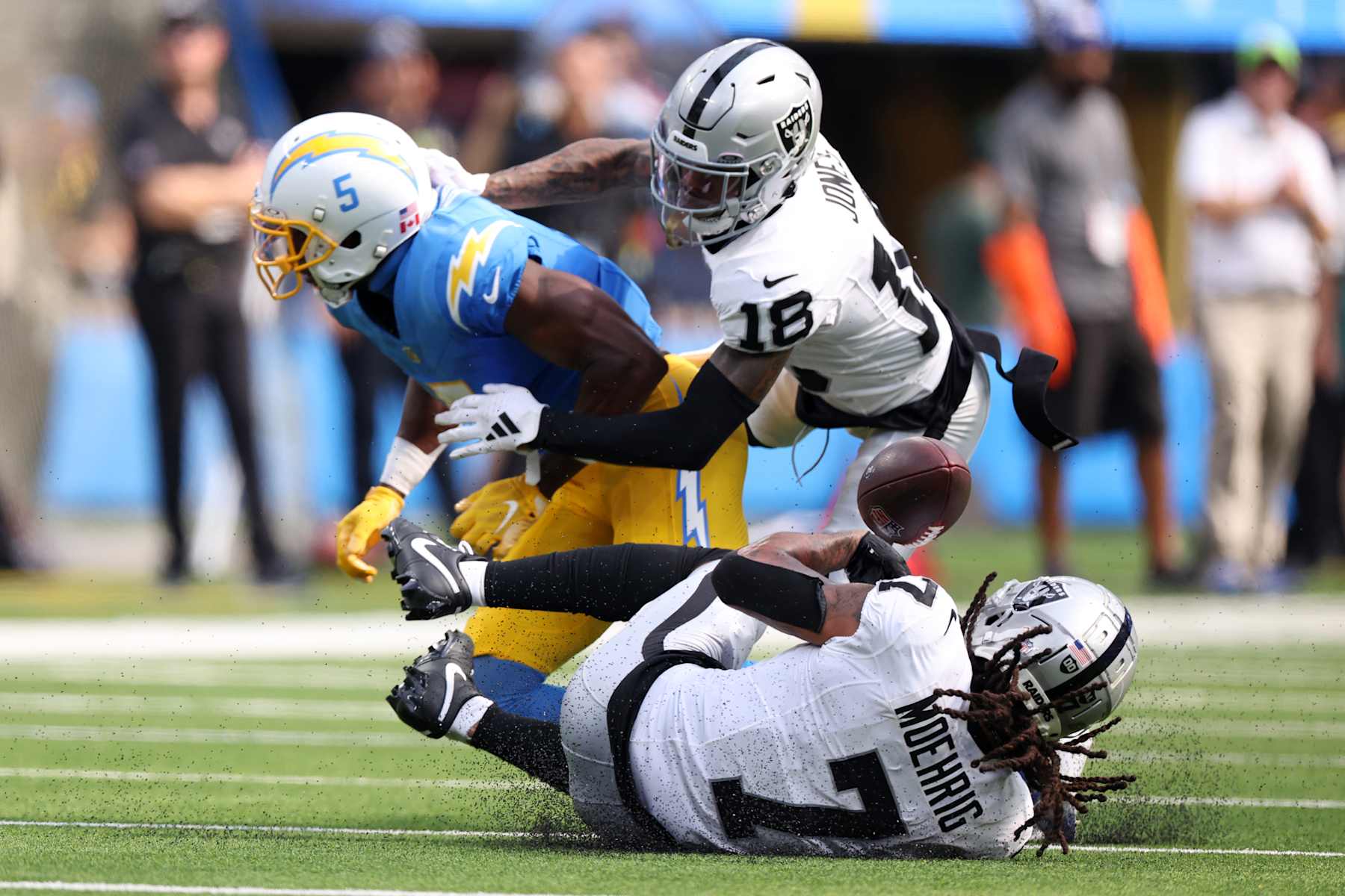INGLEWOOD, CALIFORNIA - SEPTEMBER 08: Tre'von Moehrig #7 and Jack Jones #18 of the Las Vegas Raiders break up a pass intended for Joshua Palmer #5 of the Los Angeles Chargers during the third quarter at SoFi Stadium on September 08, 2024 in Inglewood, California. (Photo by Harry How/Getty Images)
