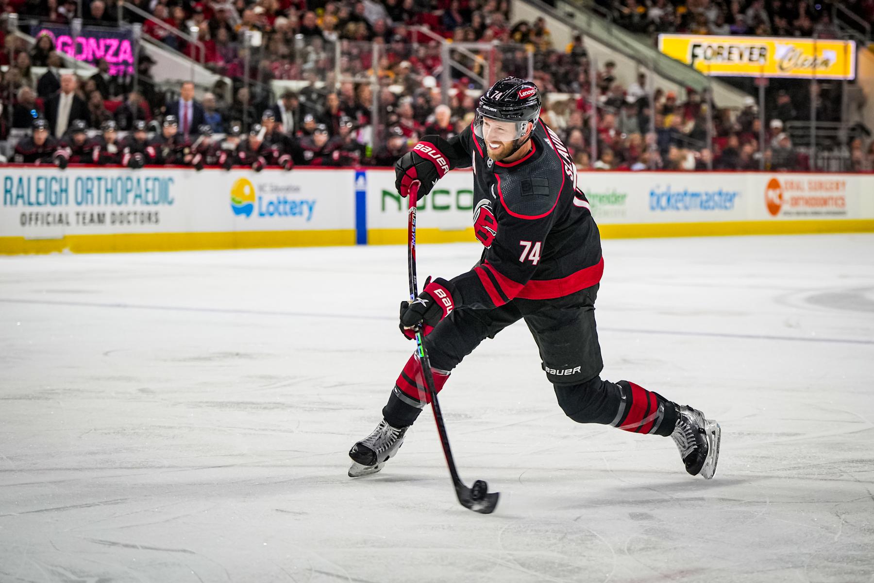 RALEIGH, NORTH CAROLINA - APRIL 04:  Jaccob Slavin #74 of the Carolina Hurricanes shoots the puck during the first period against the Boston Bruins at PNC Arena on April 4, 2024 in Raleigh, North Carolina. (Photo by Josh Lavallee/NHLI via Getty Images)