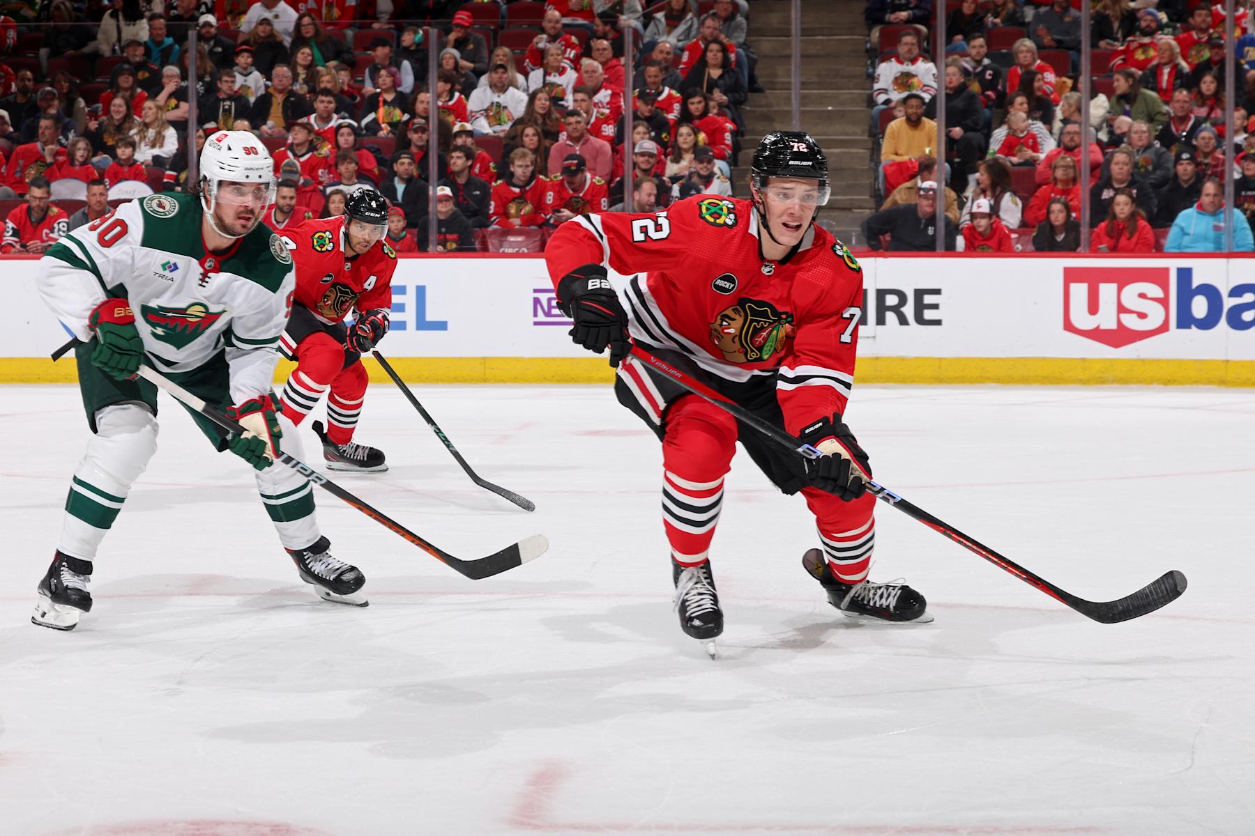 CHICAGO, ILLINOIS - APRIL 07: Alex Vlasic #72 of the Chicago Blackhawks and Marcus Johansson #90 of the Minnesota Wild watch for the puck in the first period at the United Center on April 07, 2024 in Chicago, Illinois. (Photo by Chase Agnello-Dean/NHLI via Getty Images)